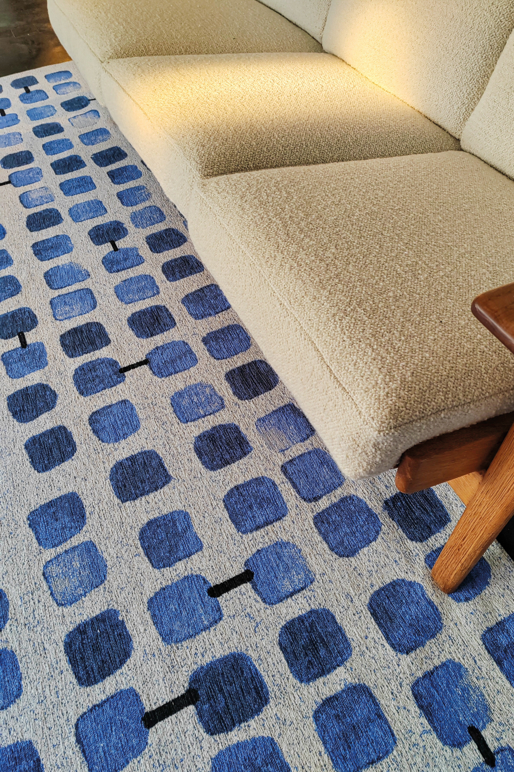 Modern blue rug with repeated peach motif pattern
