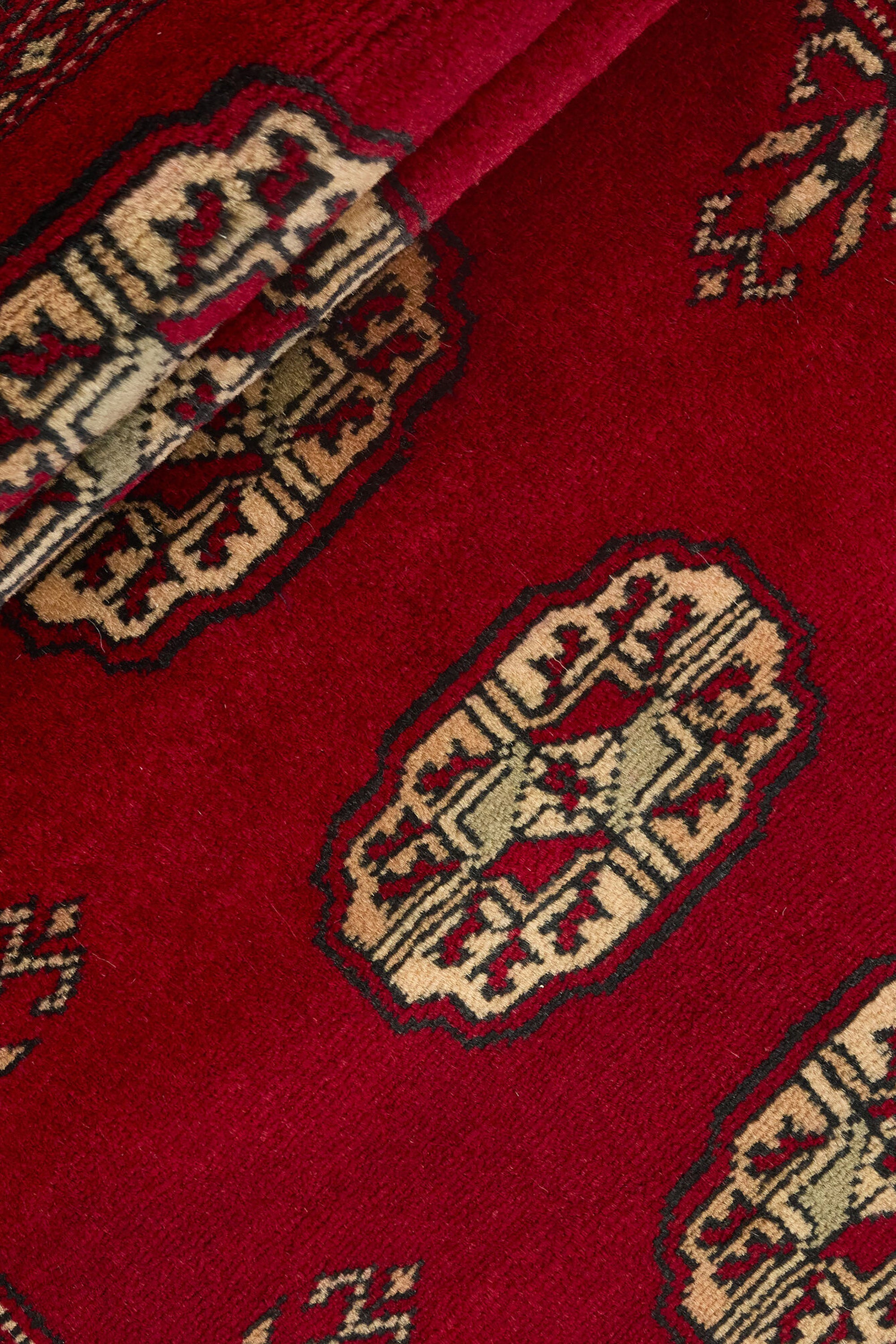 Red Oriental runner with traditional bordered pattern