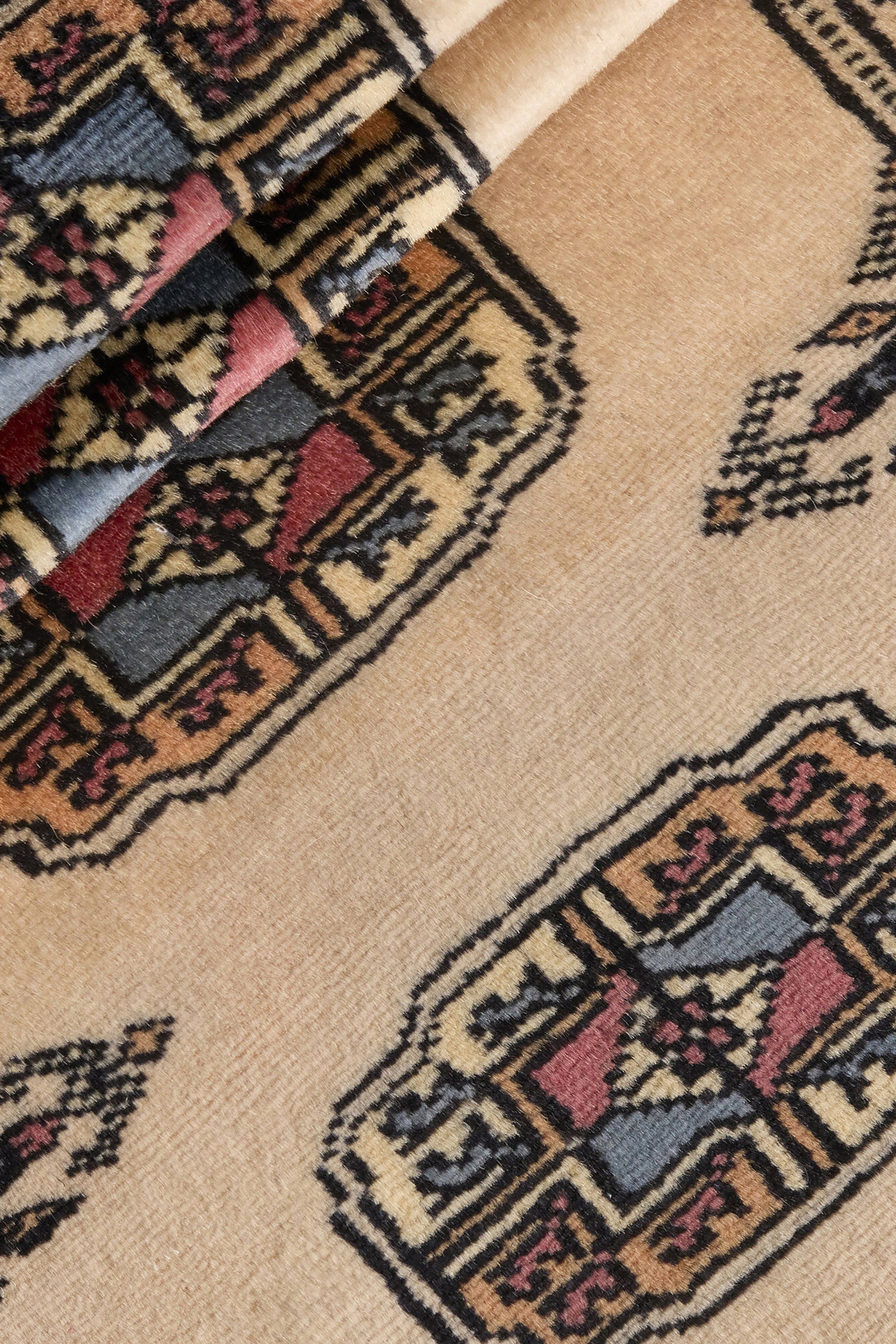 Beige Oriental runner with traditional bordered pattern