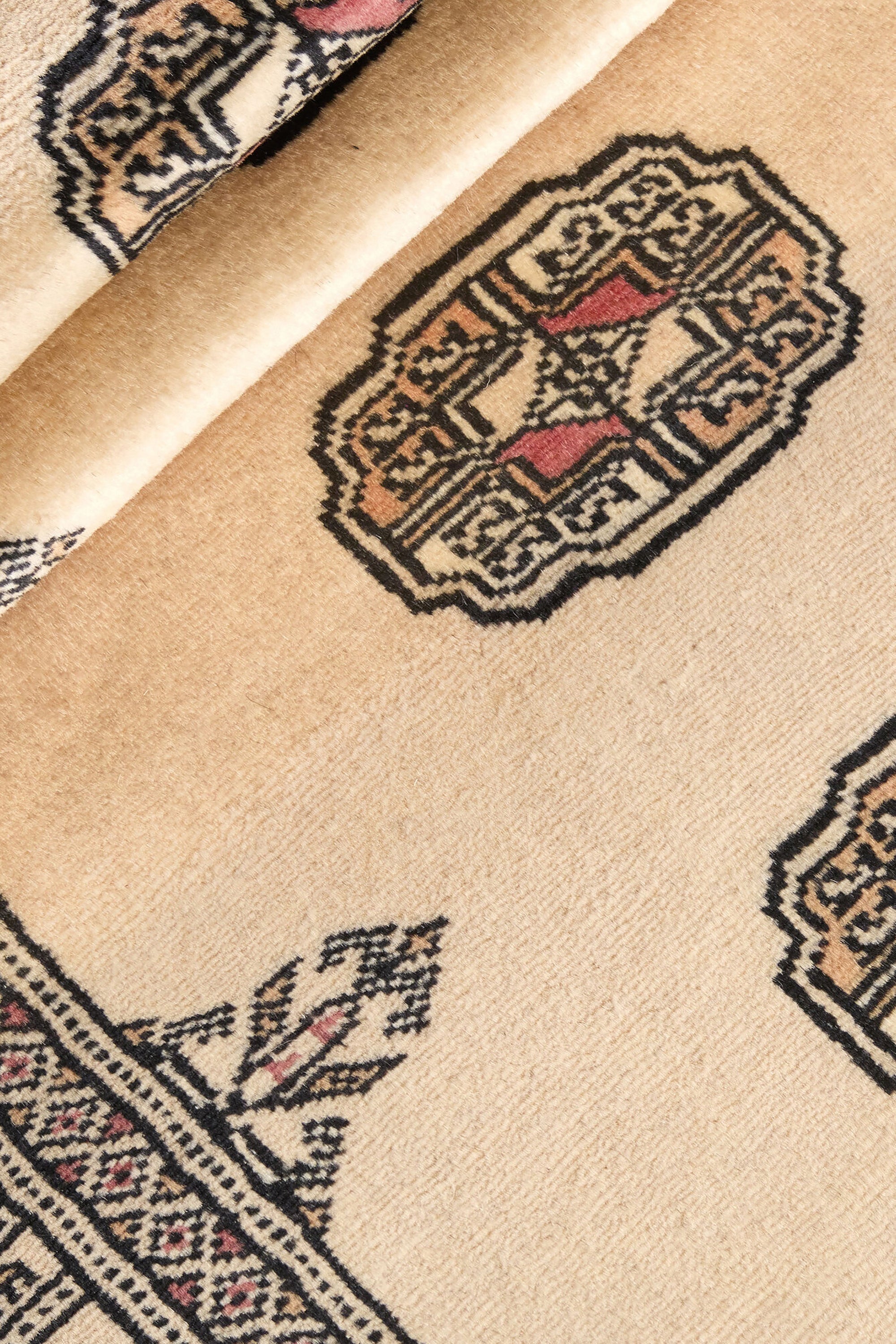 Beige Oriental runner with traditional bordered pattern