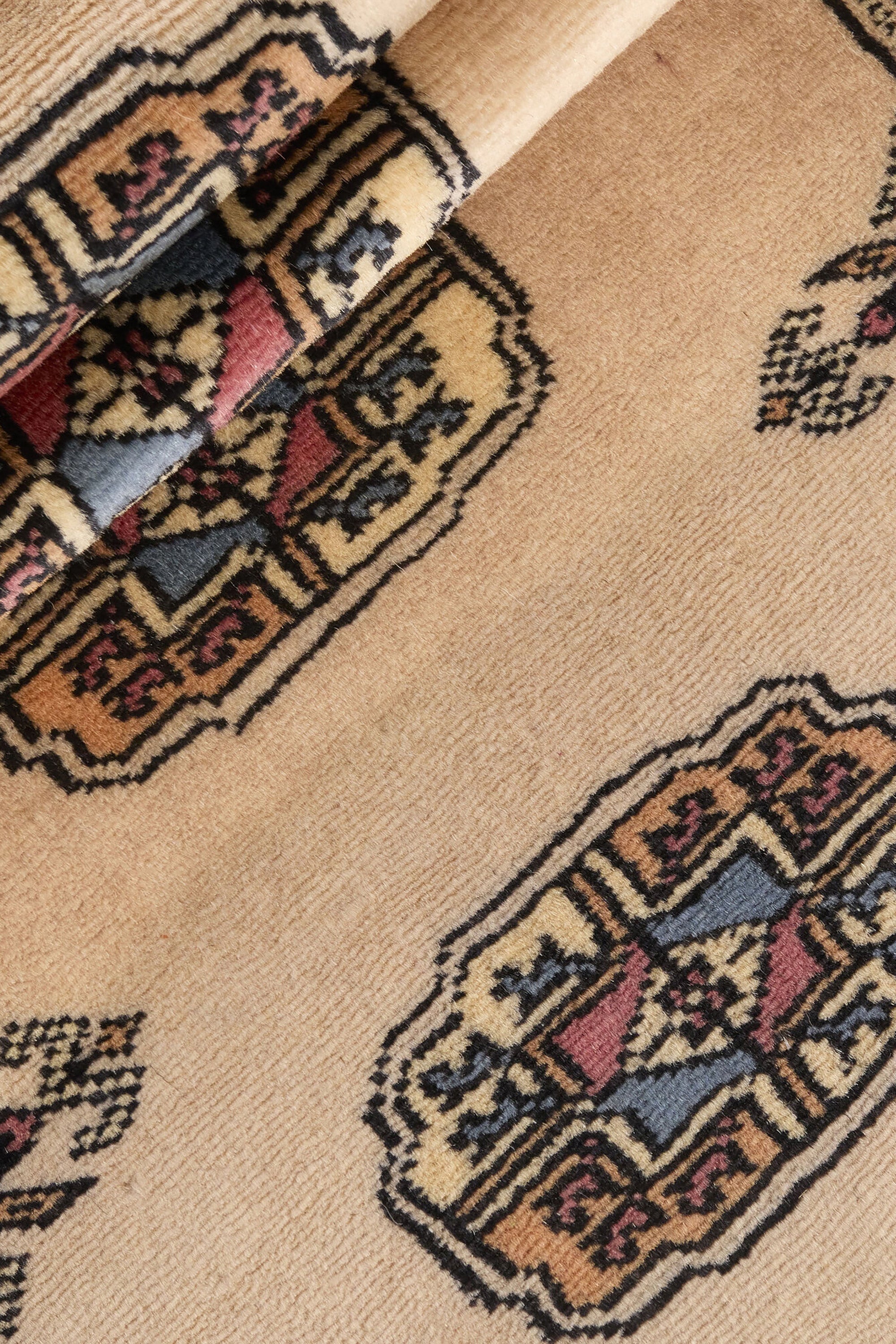 Beige Oriental runner with traditional bordered pattern