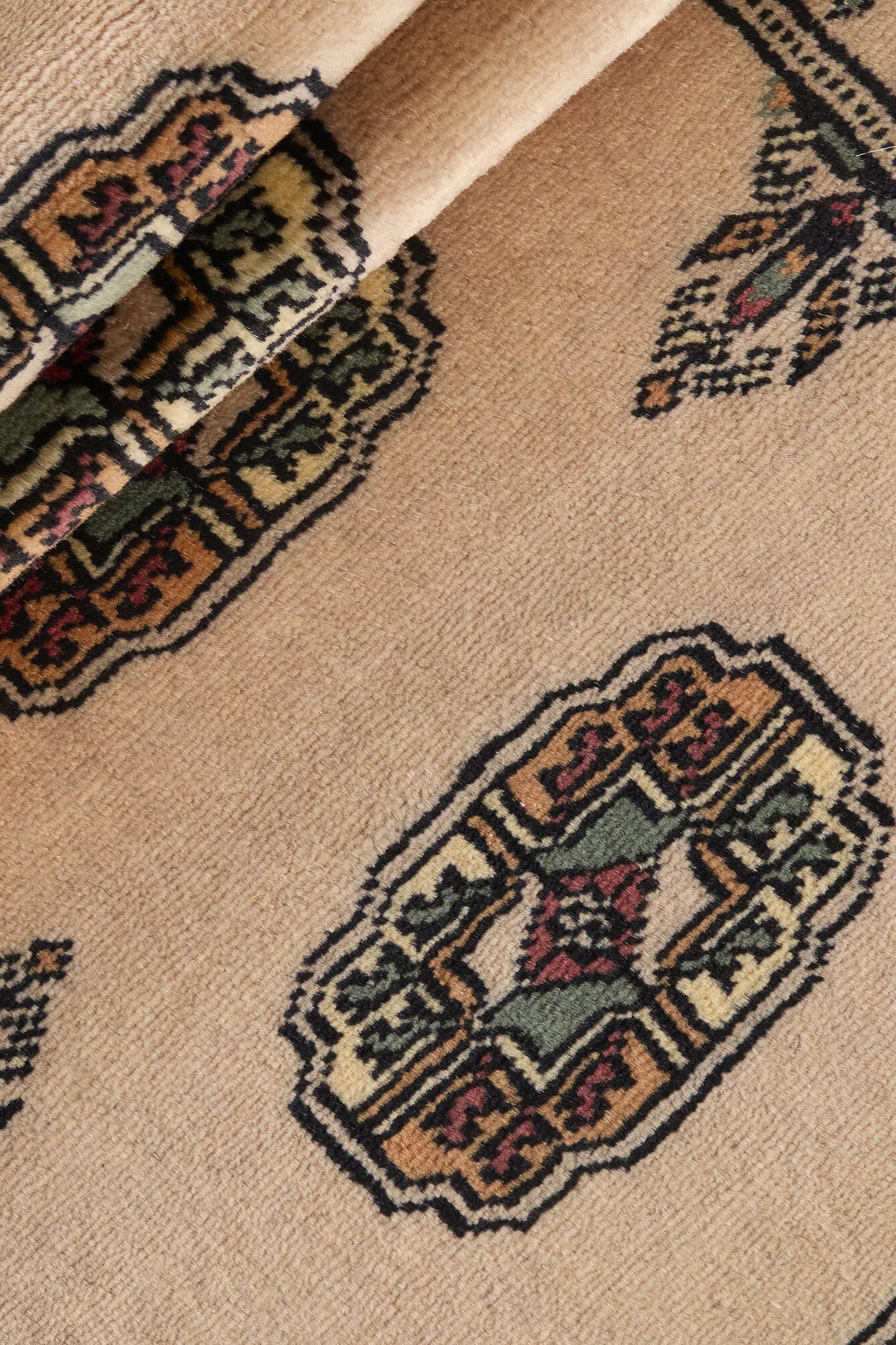 Beige Oriental runner with traditional bordered pattern