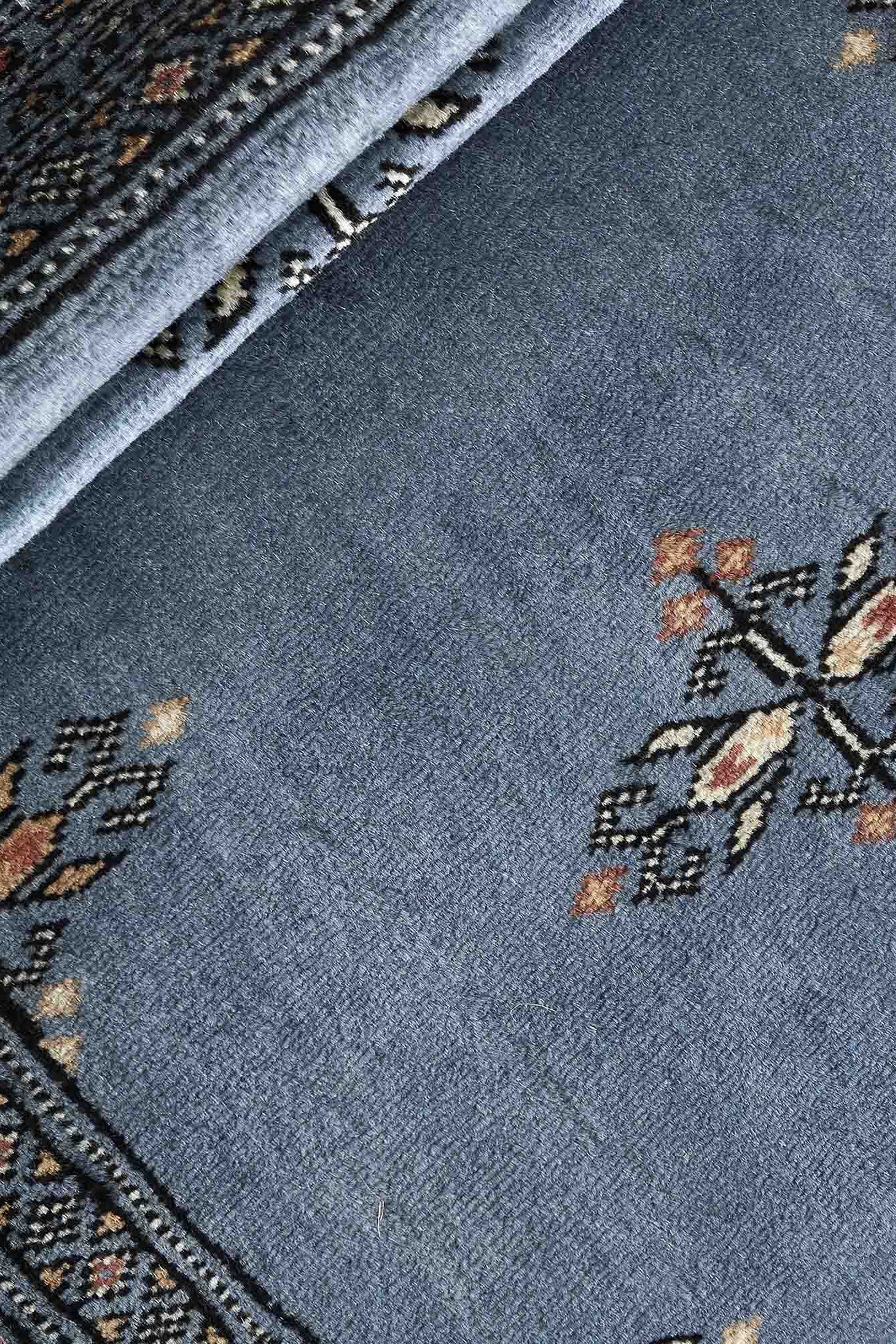 Blue Oriental runner with traditional bordered pattern