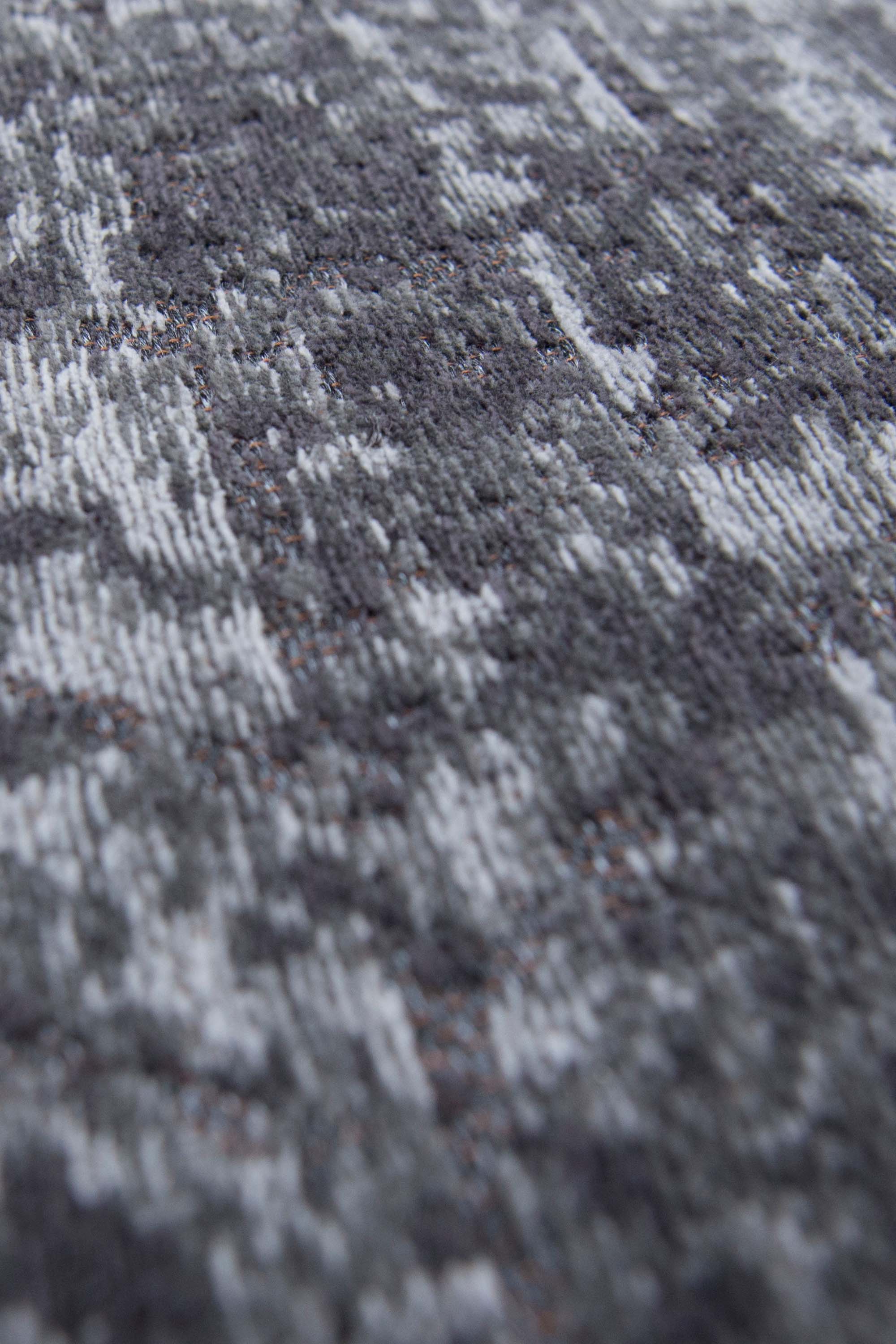 Black flatweave rug with faded grey chevron pattern