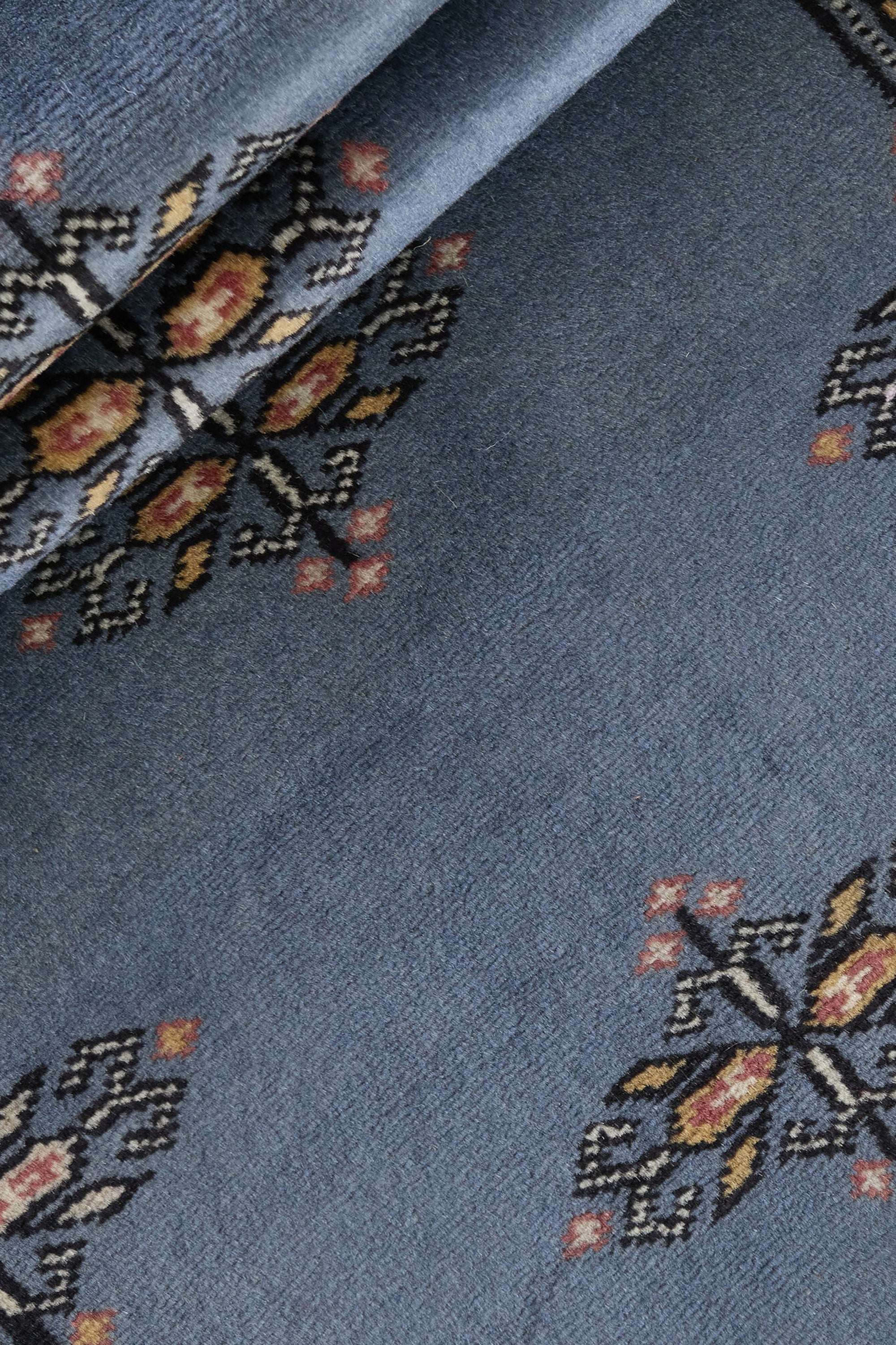 Blue Oriental runner with traditional bordered pattern