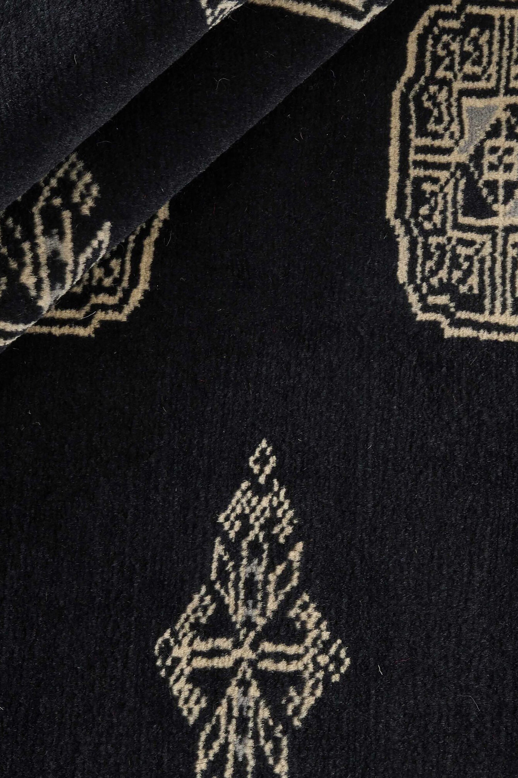 Black Oriental runner with traditional bordered pattern