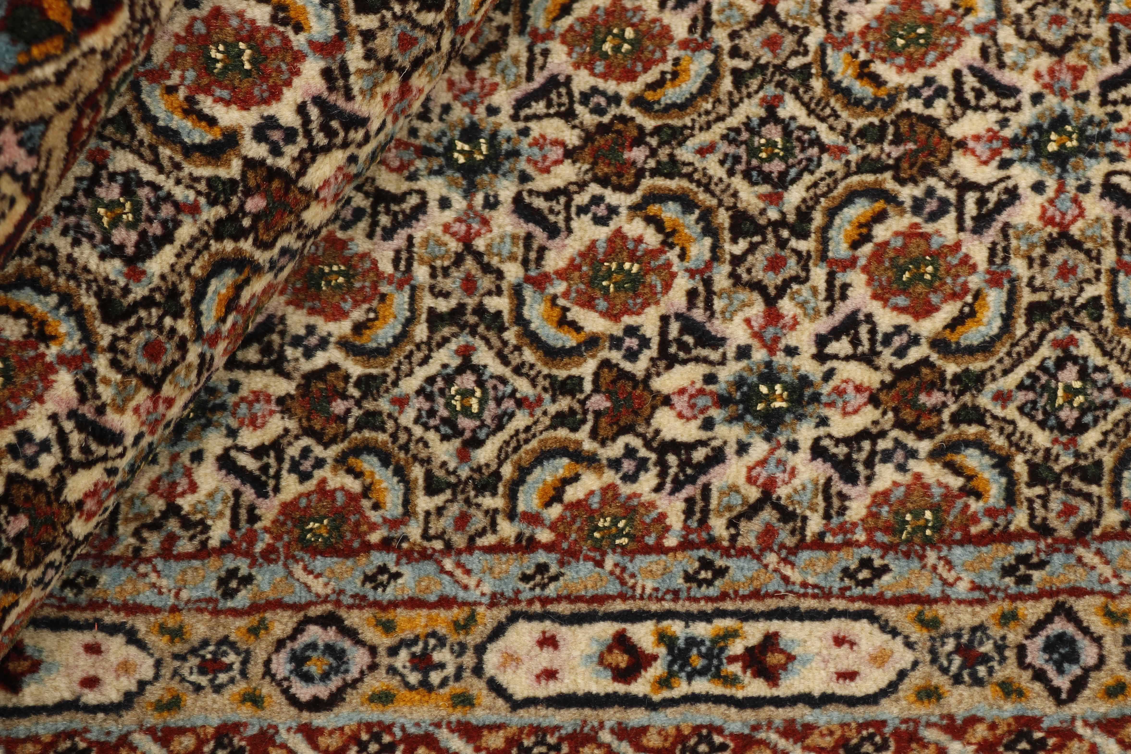 authentic persian rug with traditional floral pattern in cream