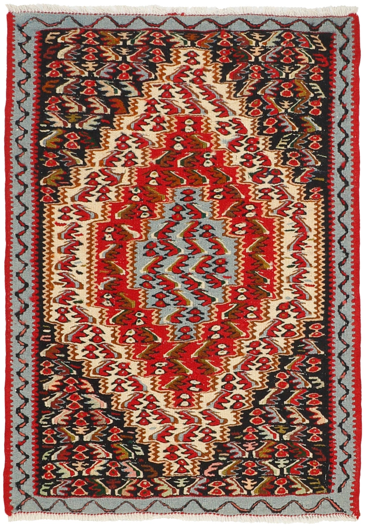 Rectangular natural beige rug with terracotta red, grey and black aztec design and black tassel border