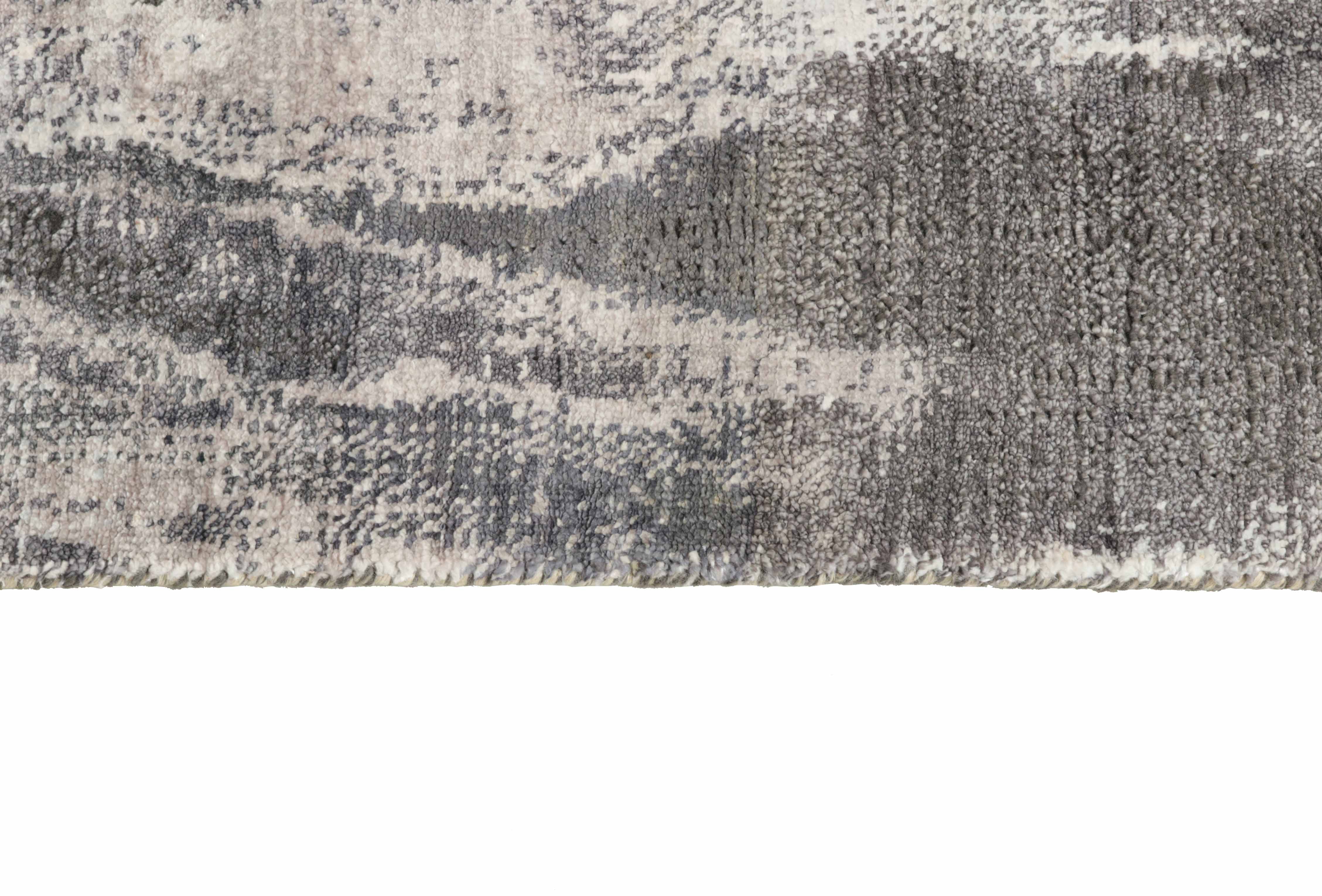 Large area rug with abstract design in grey and charcoal