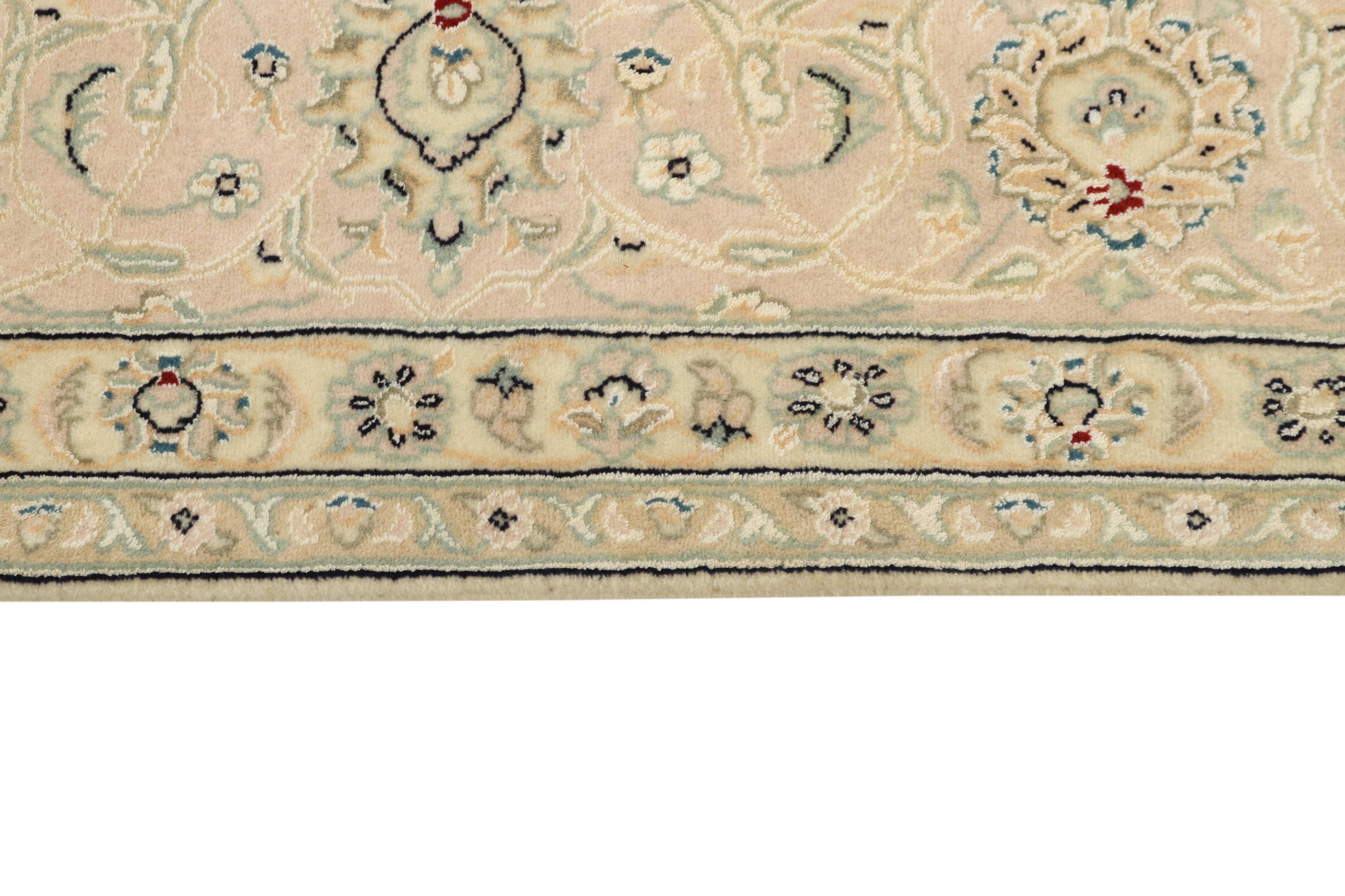 Authentic oriental rug with traditional floral design in ivory and beige