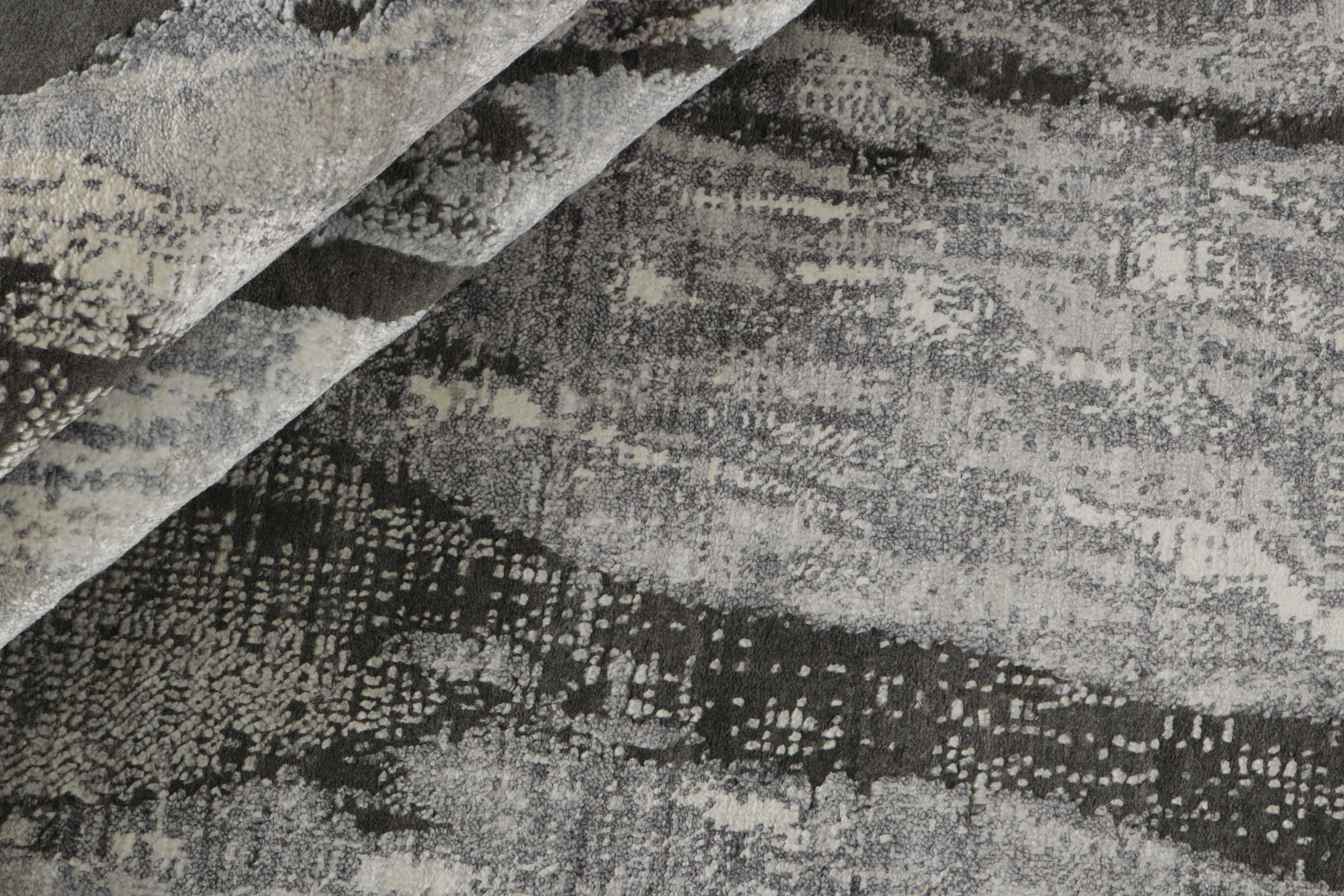 Large area rug with abstract design in grey and charcoal