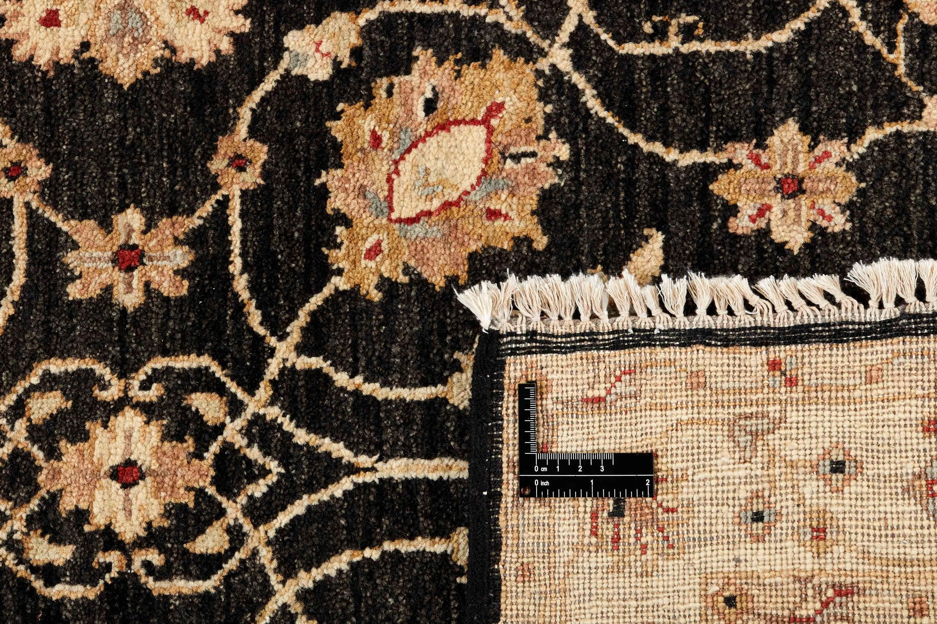 oriental rug with black and beige floral pattern