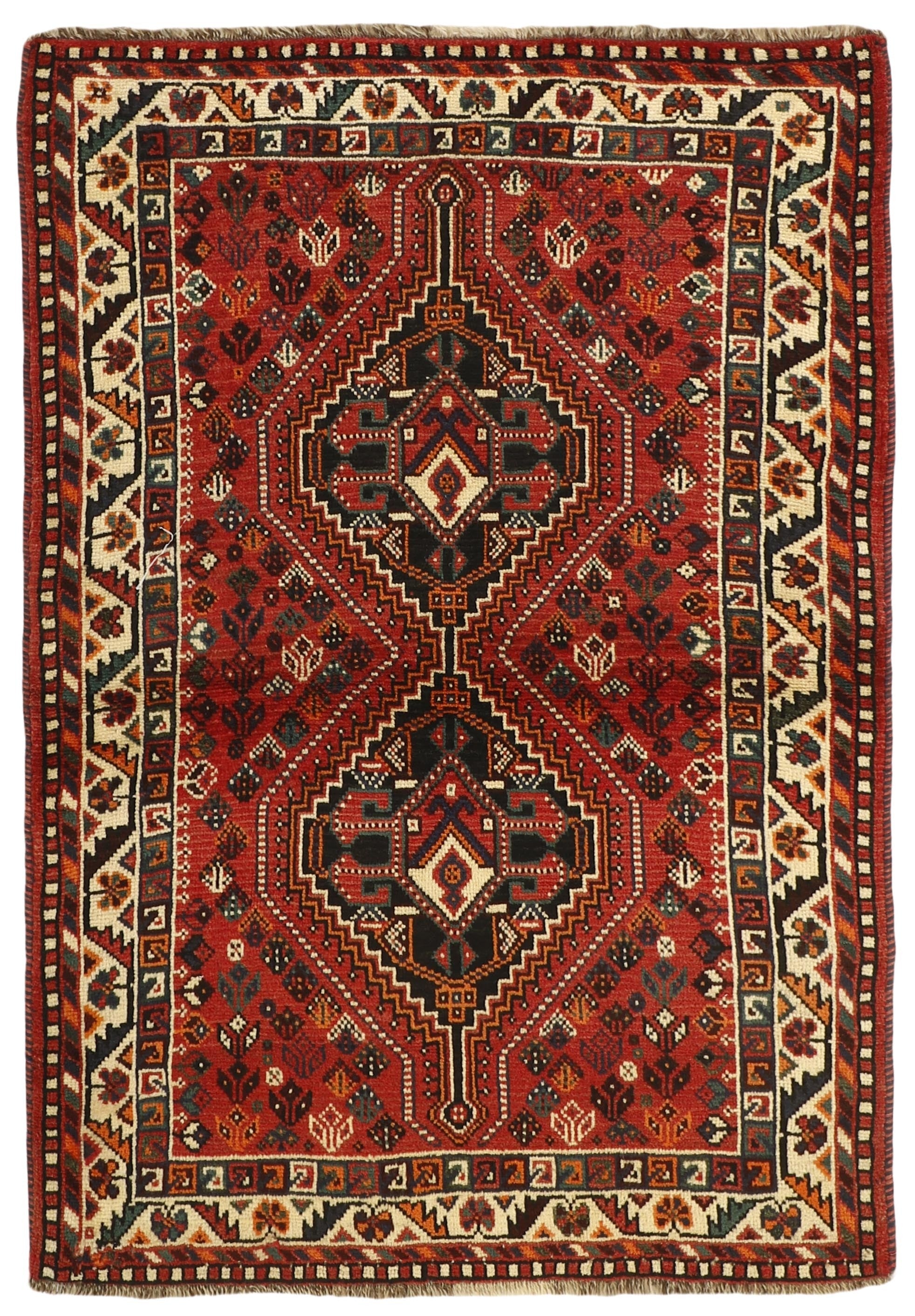 Authentic persian rug with a traditional tribal geometric pattern in red, ivory and black