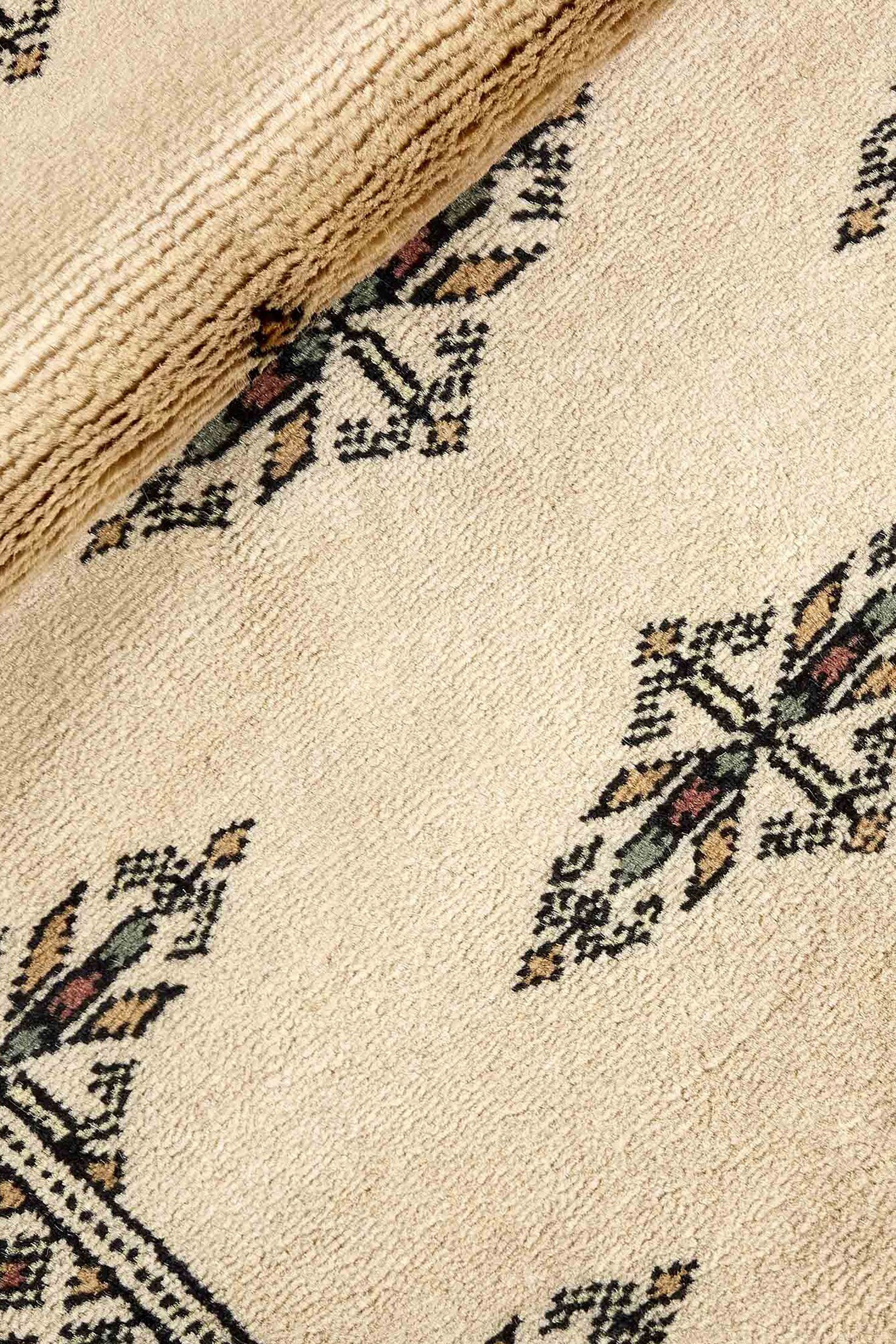 Beige Oriental runner with traditional bordered pattern