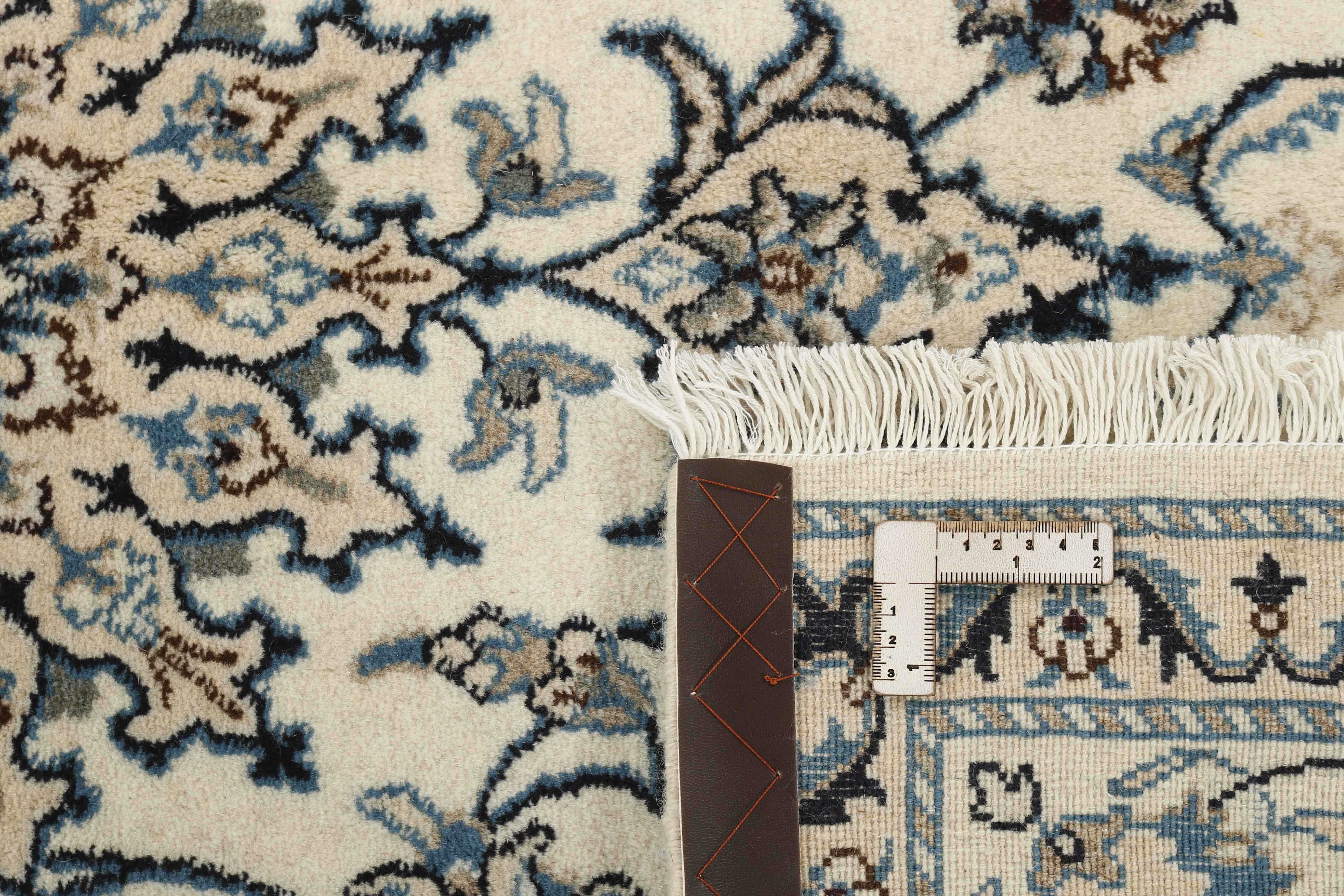 Authentic persian rug with a traditional floral design in cream and blue