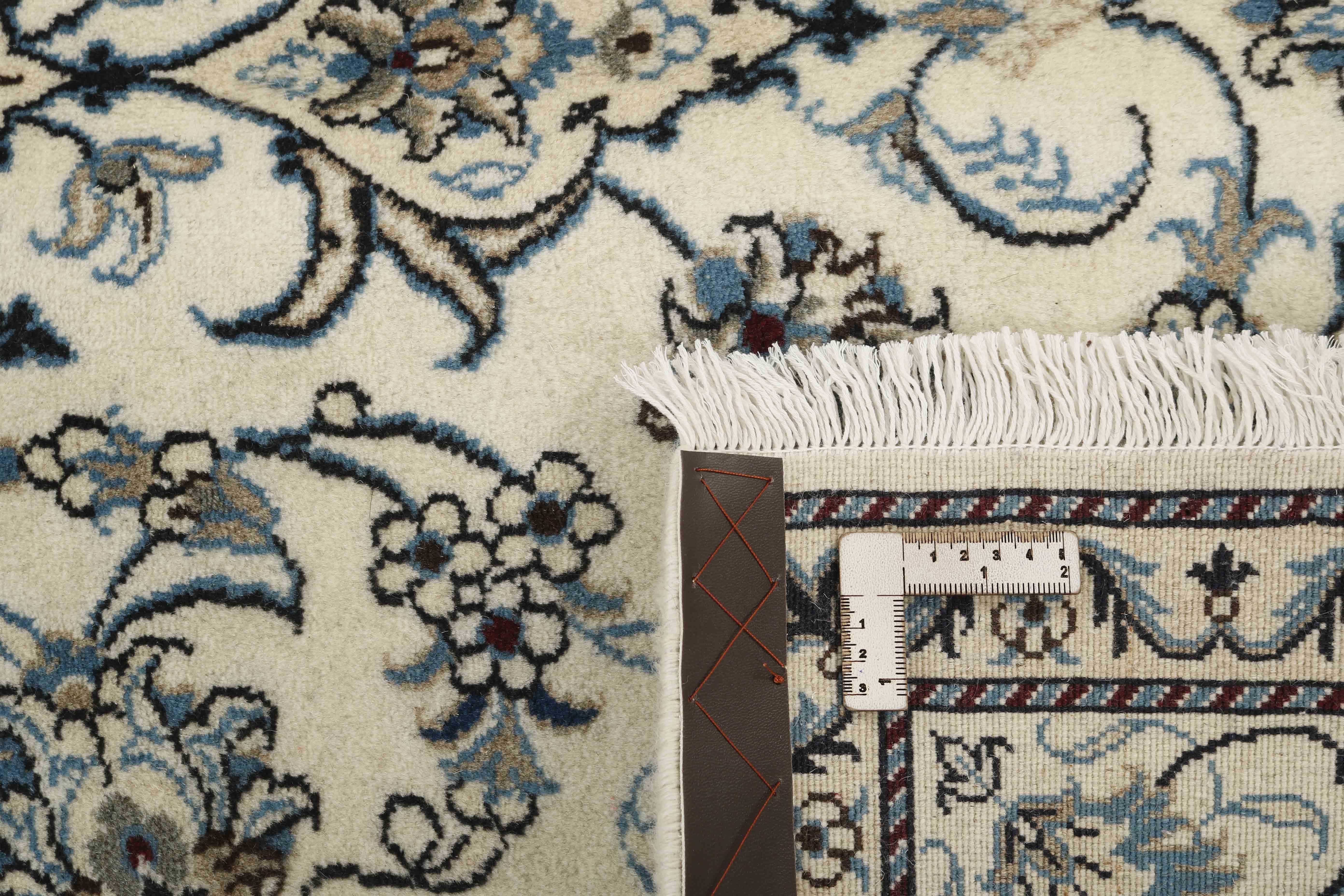 Authentic persian rug with a traditional floral design in cream and blue