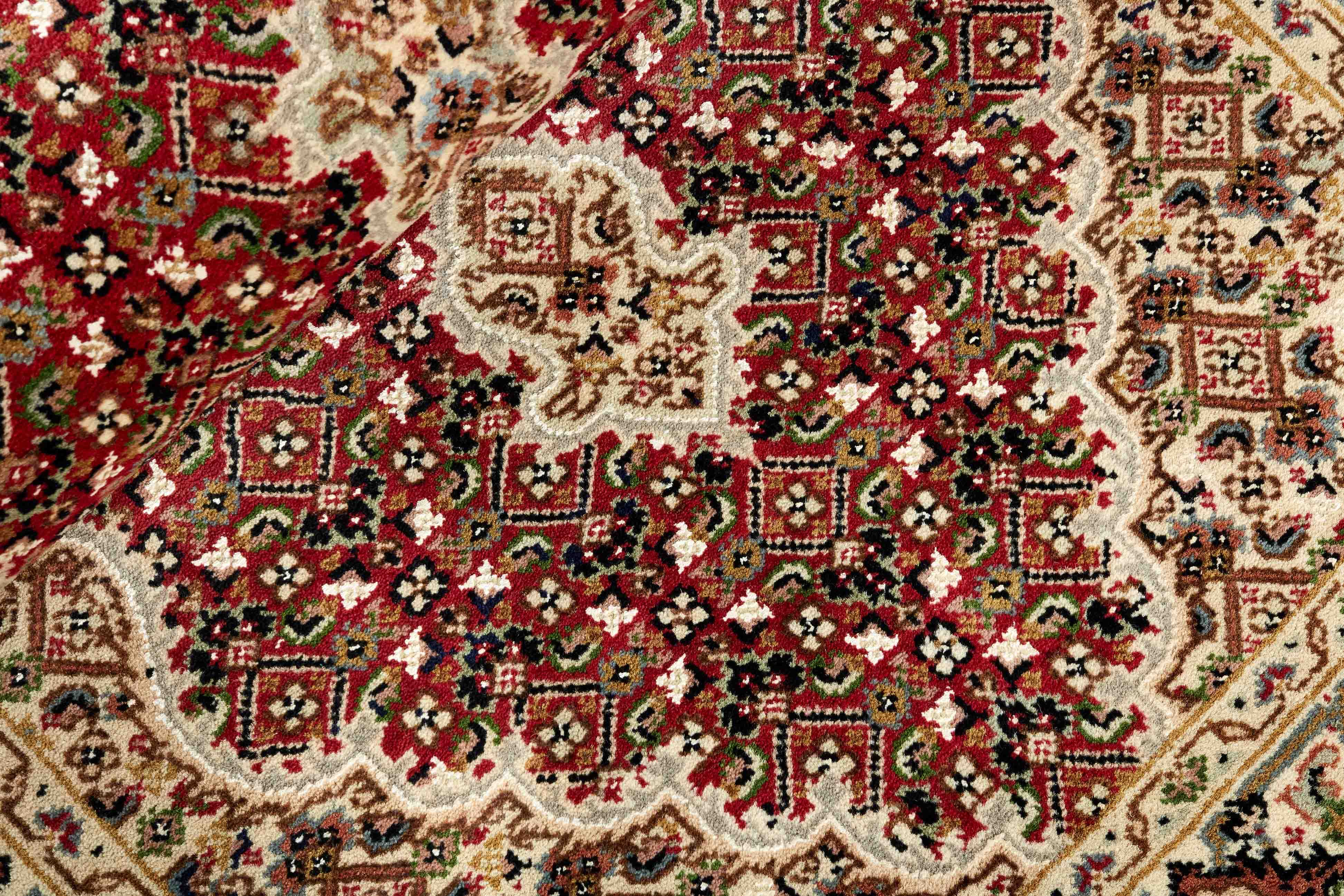 Authentic Oriental rug with traditional geometric and floral design in red