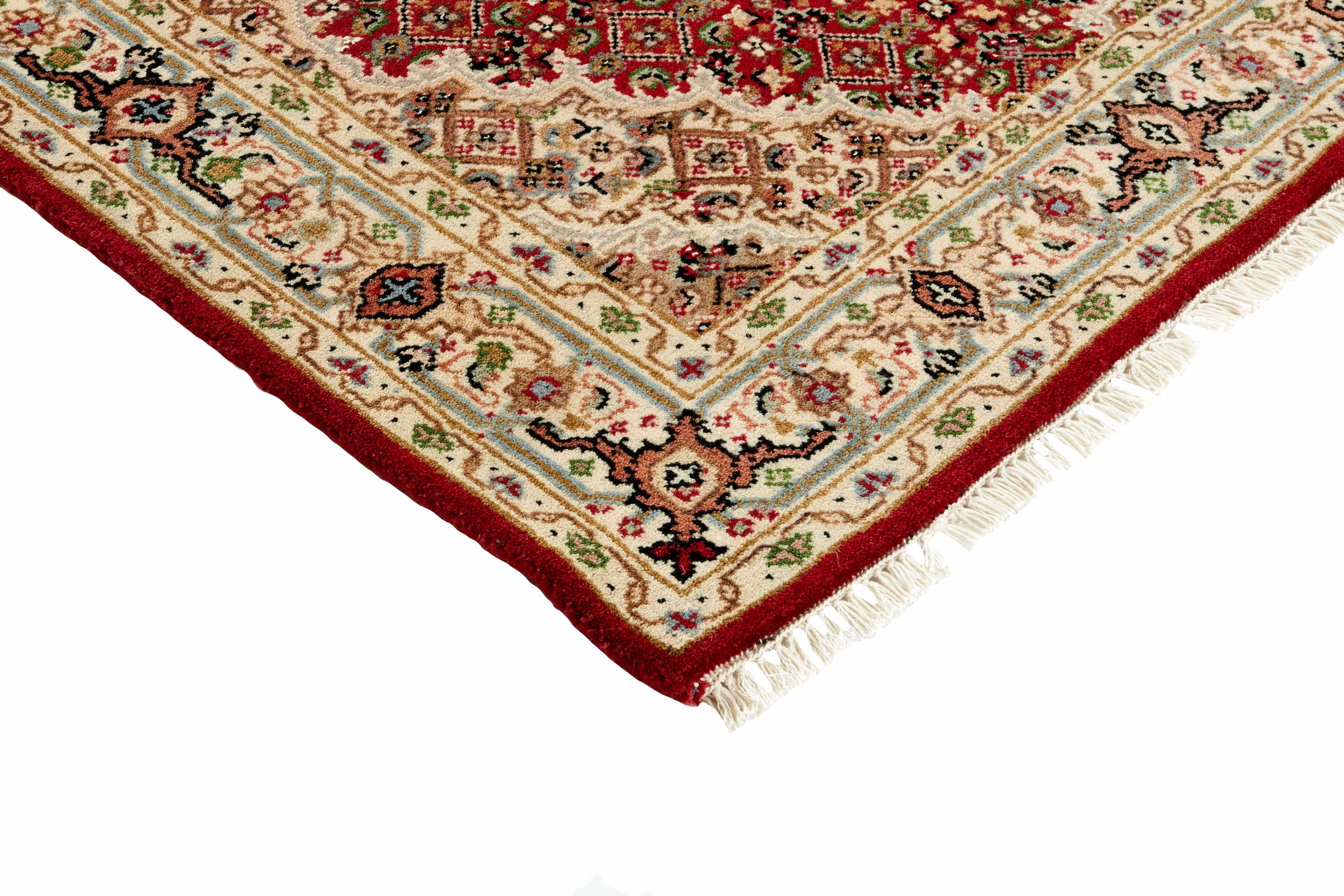 Authentic Oriental rug with traditional geometric and floral design in red