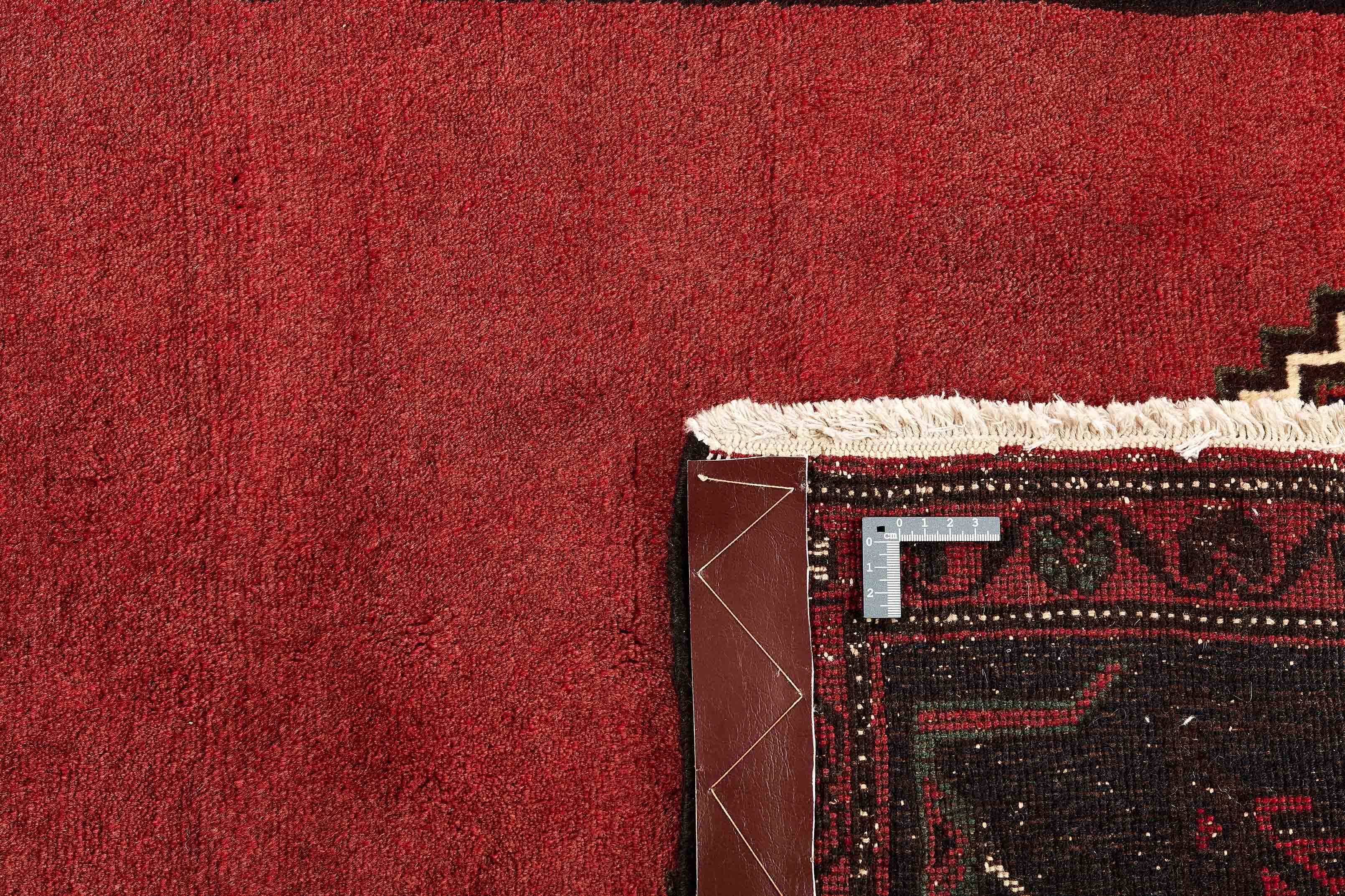 Authentic persian rug with a traditional geometric pattern in red