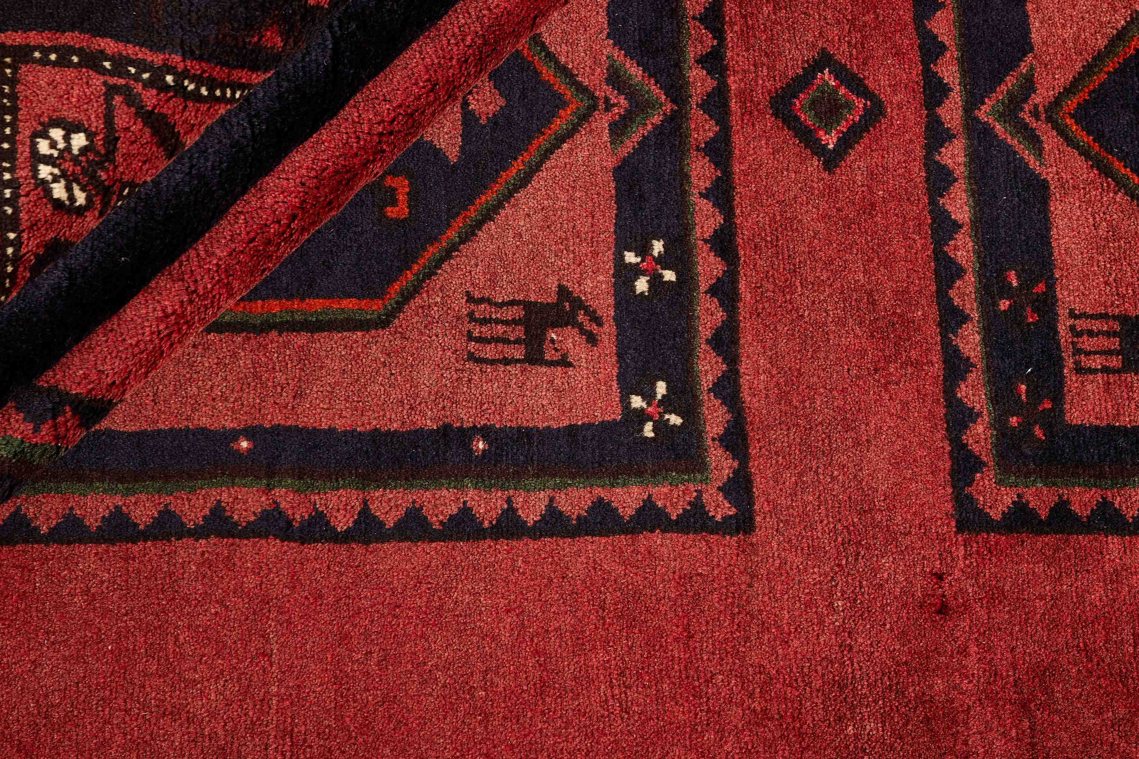 Authentic persian rug with a traditional geometric pattern in red