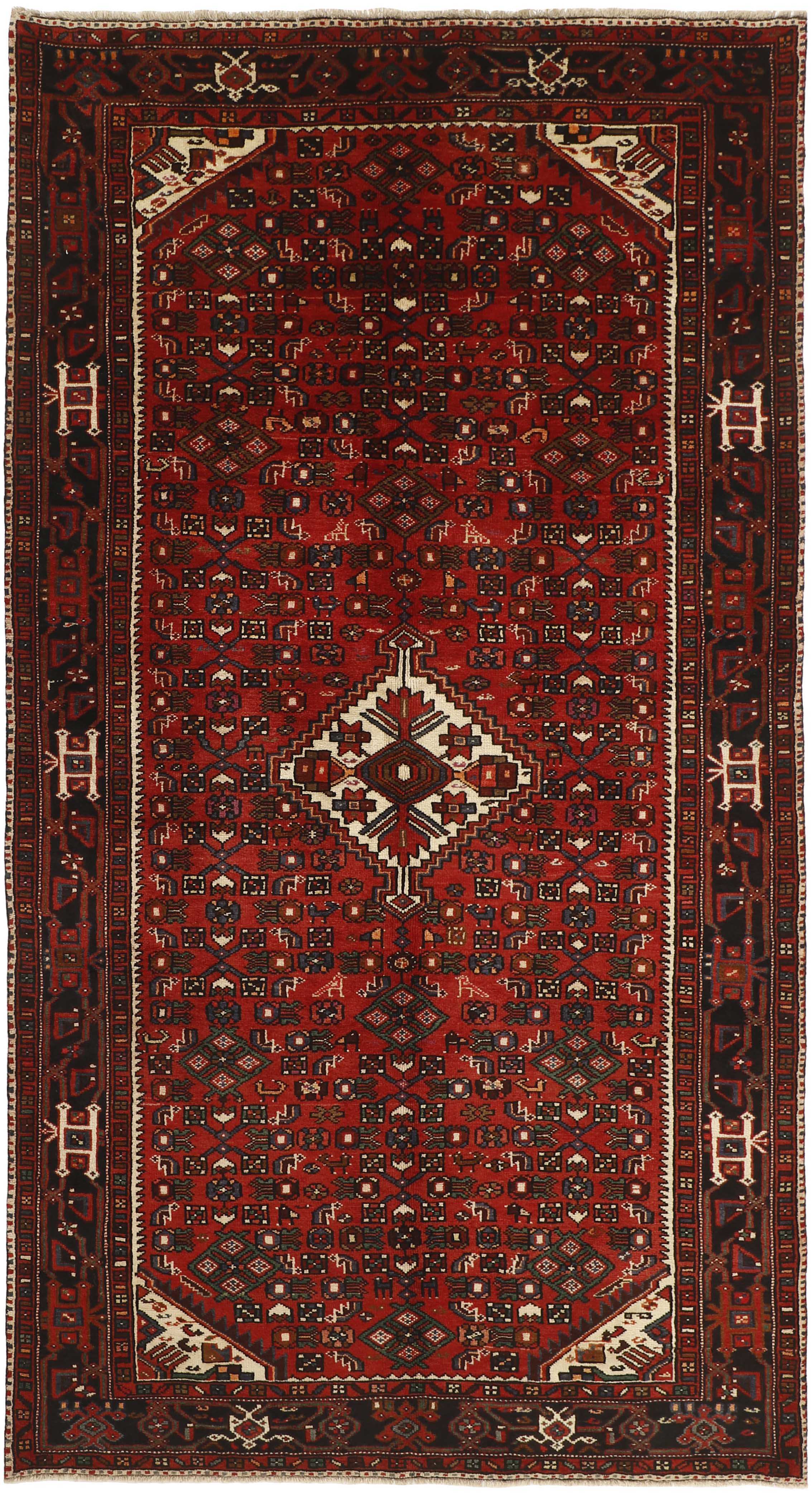 Authentic persian rug with traditional geometric tribal design in red