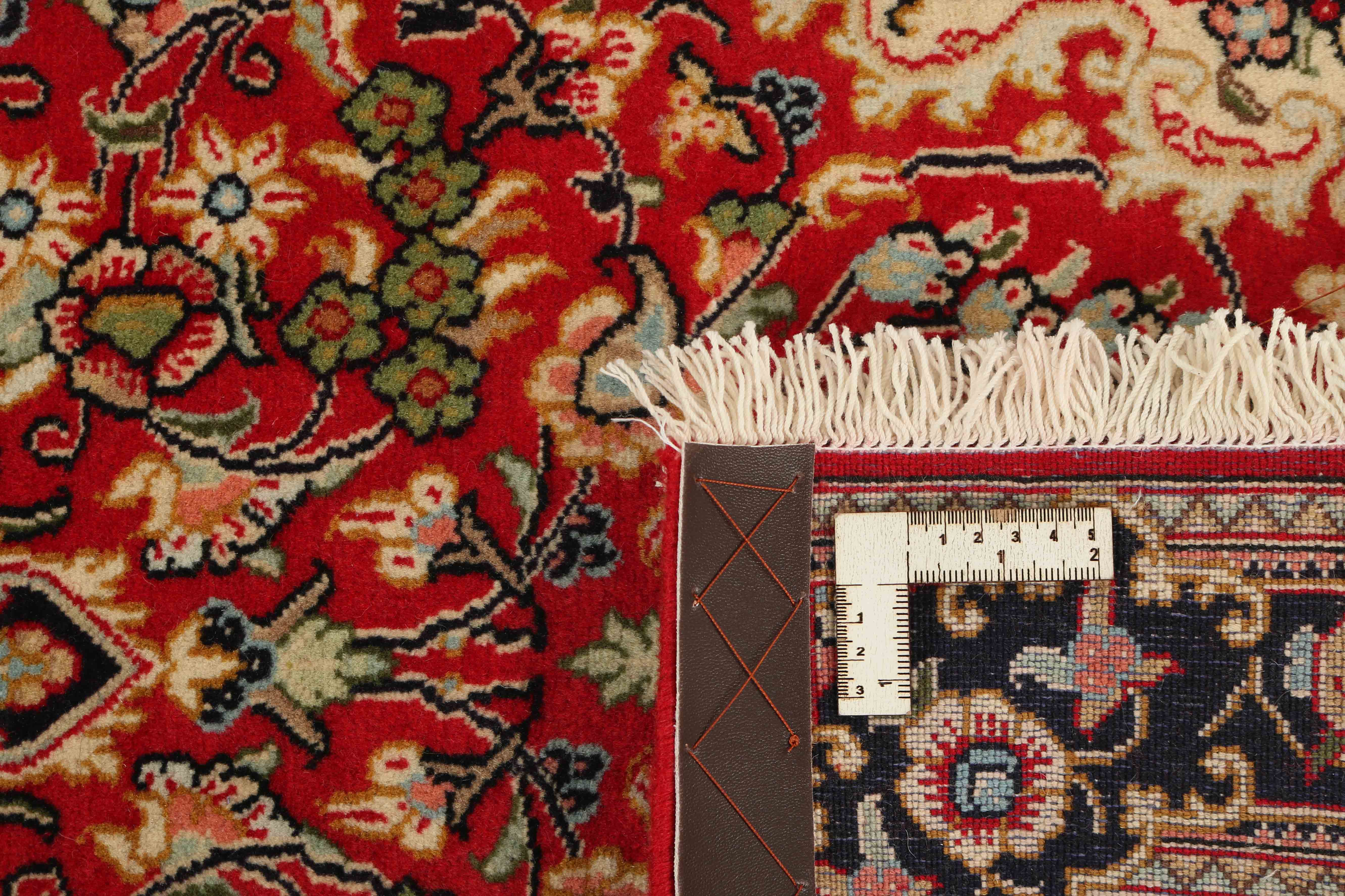 Authentic persian runner with a traditional floral design in red and beige
