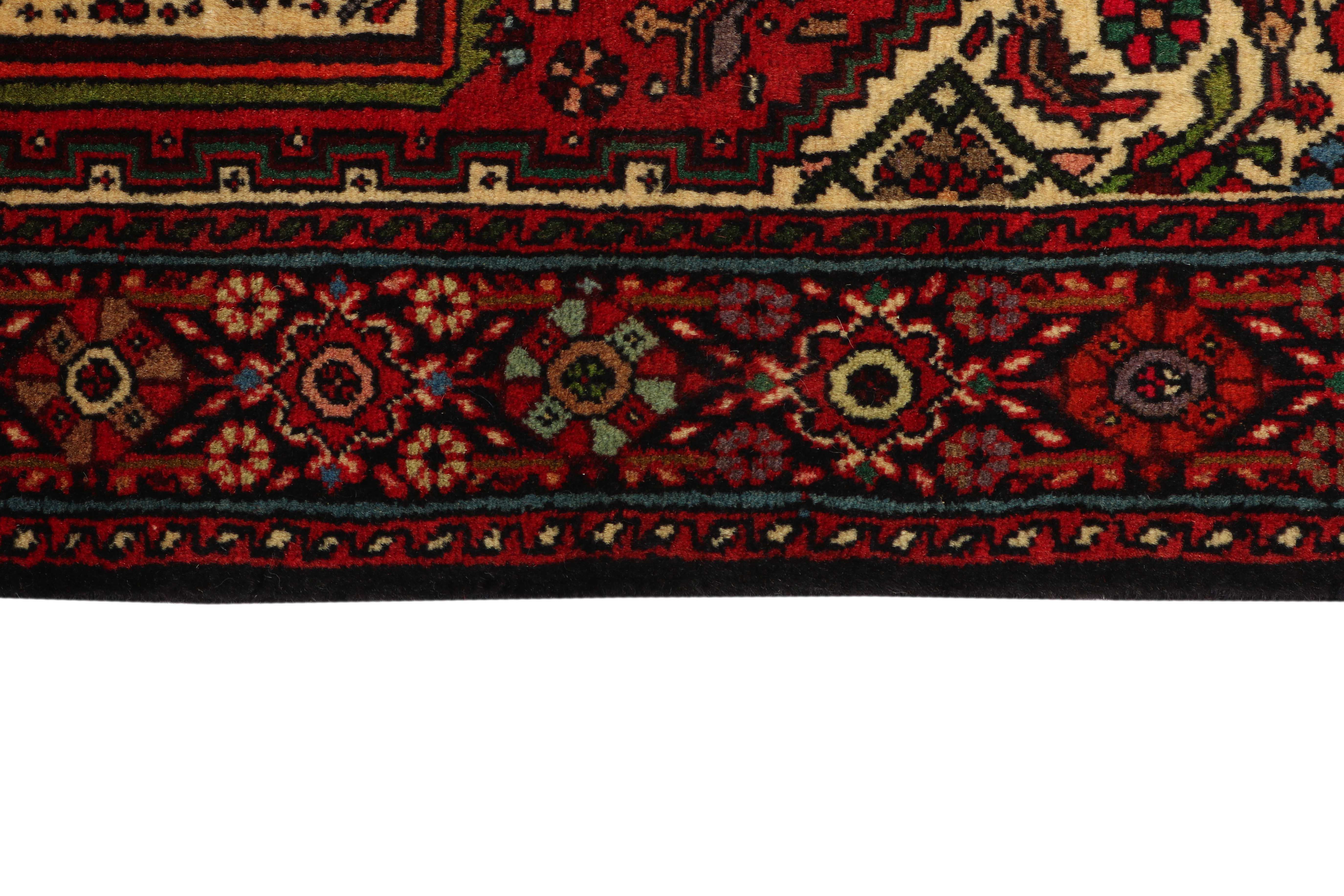 Red and beige persian rug with a floral design