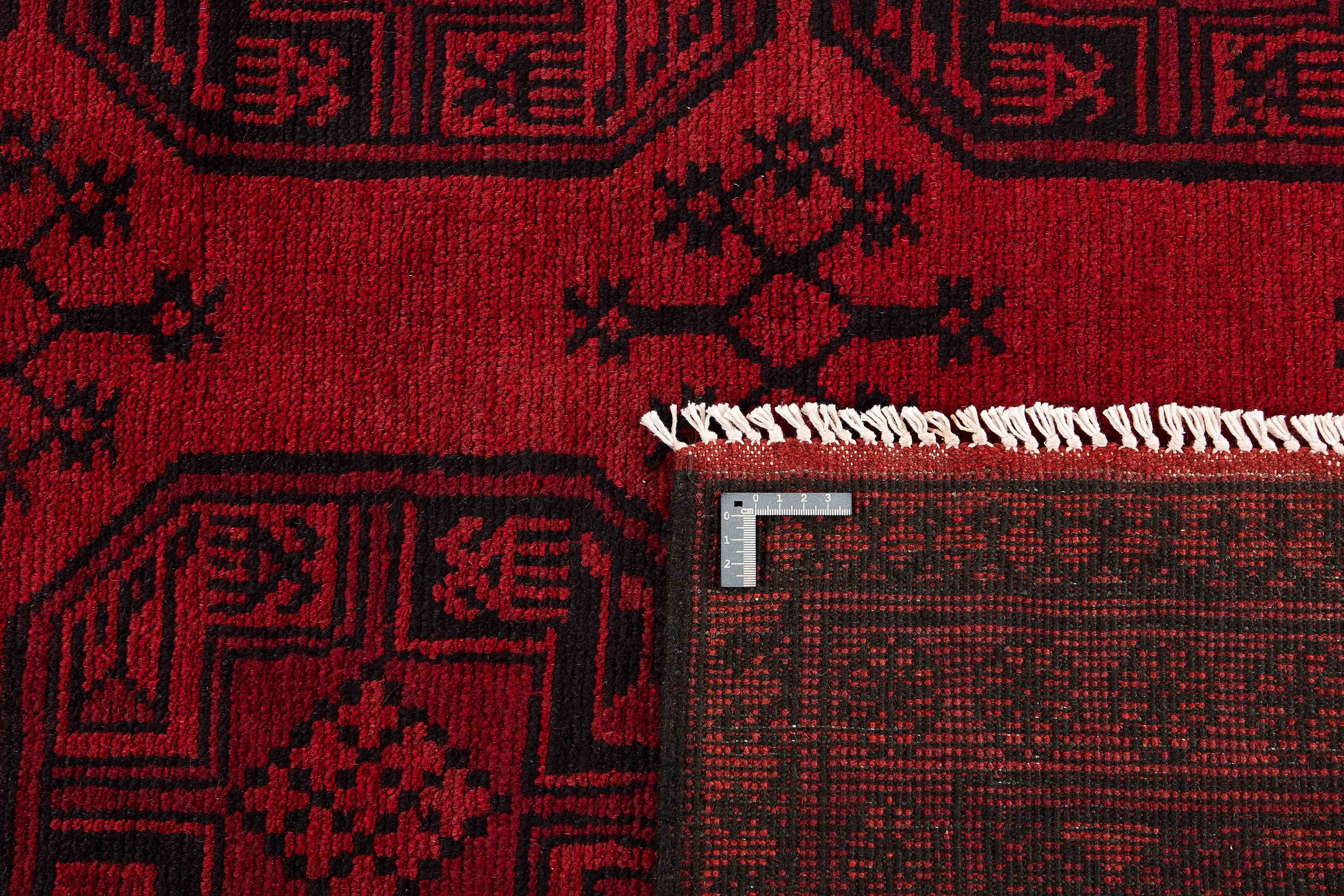 Red oriental rug with traditional elephant's foot pattern