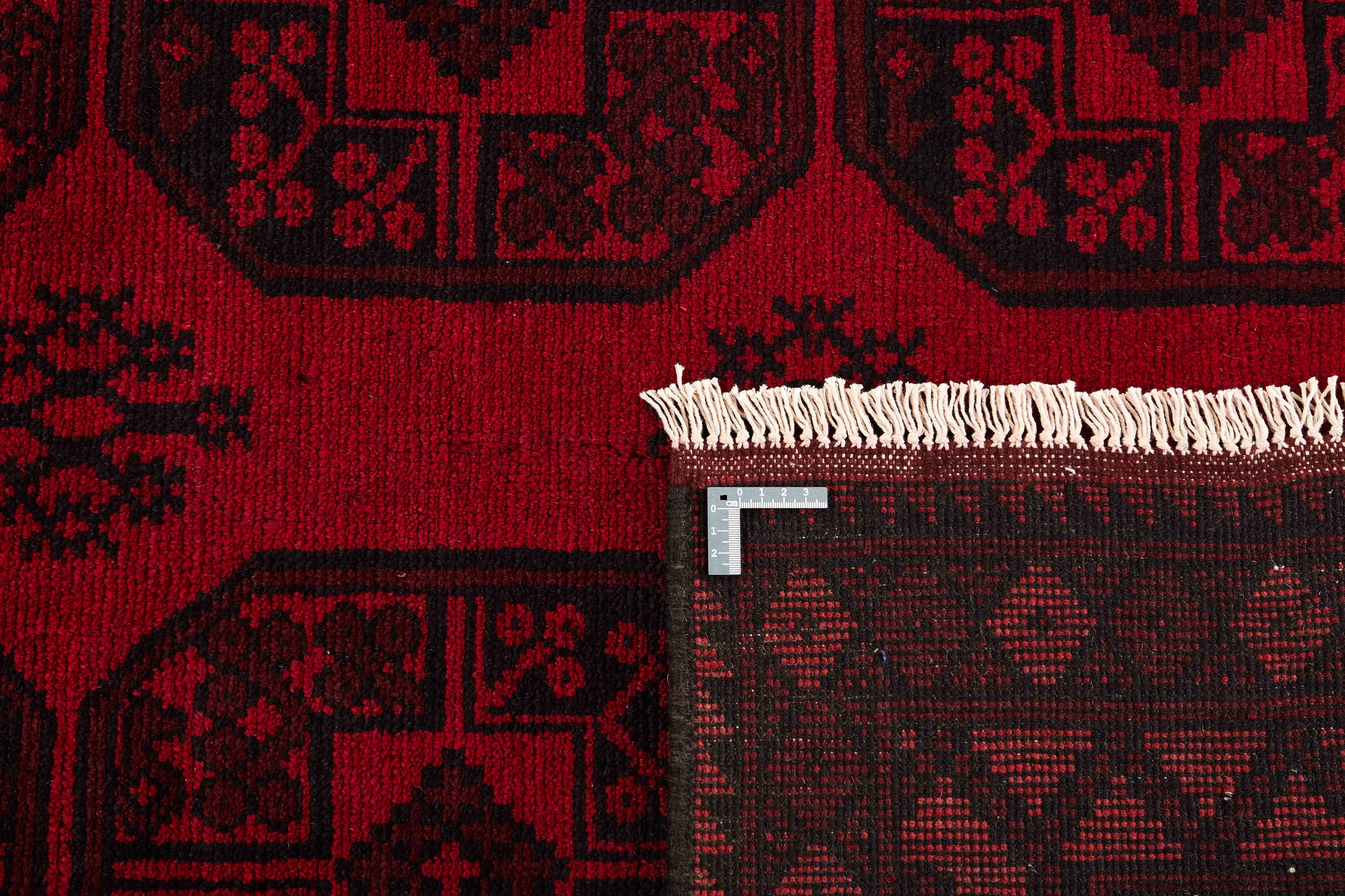 Red oriental rug with traditional elephant's foot pattern