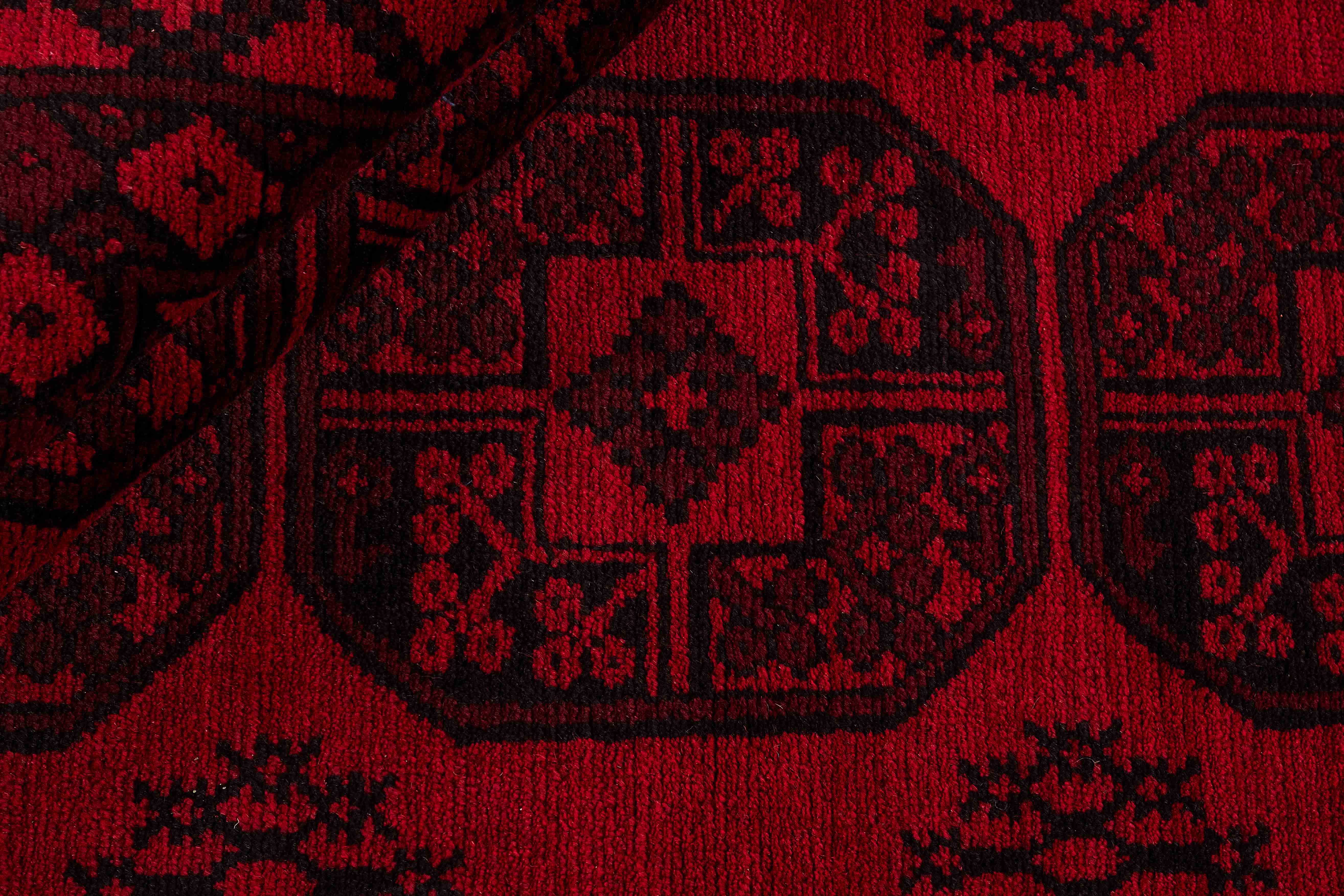 Red oriental rug with traditional elephant's foot pattern