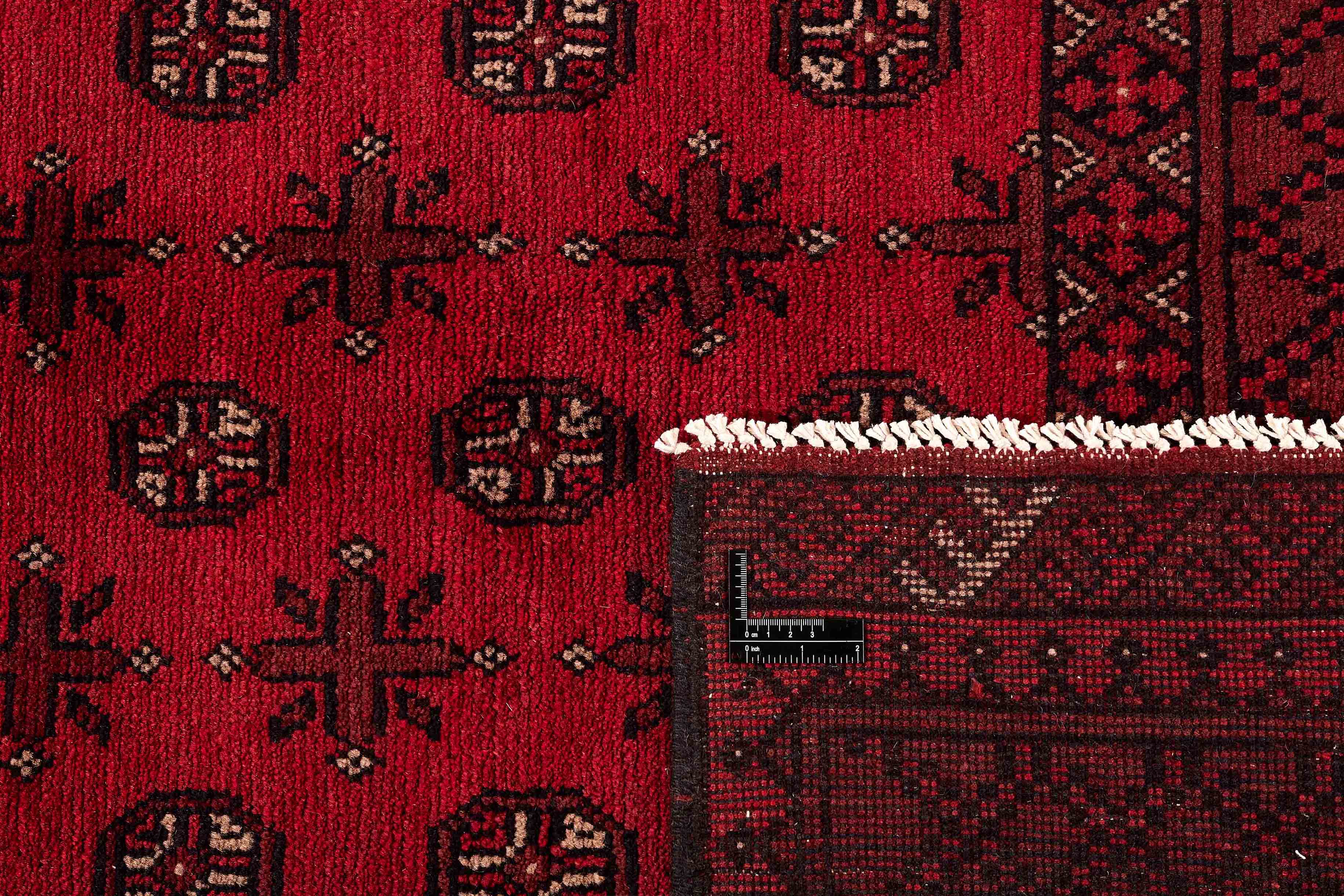 Red oriental rug with traditional elephant's foot pattern