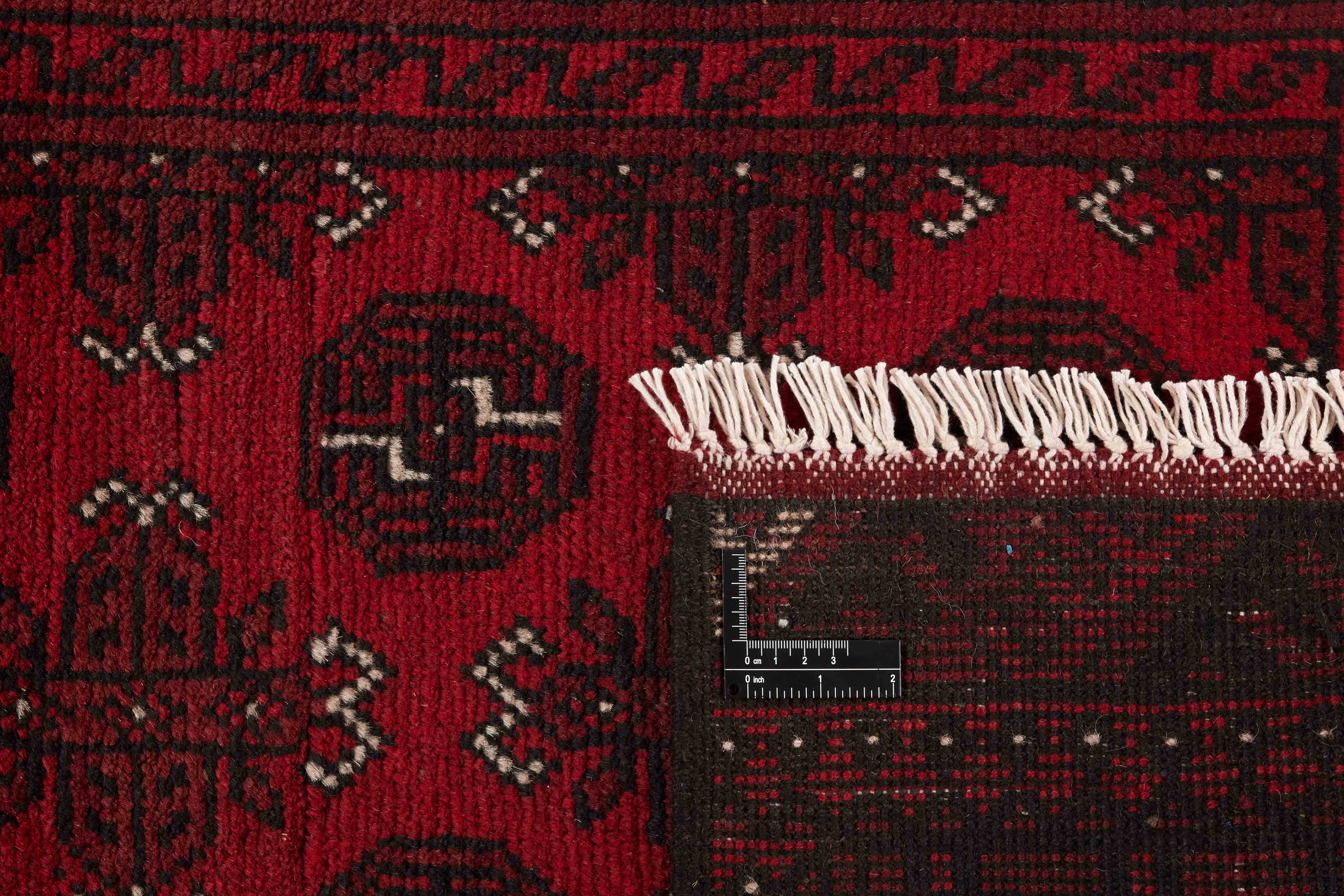 Red Oriental wool runner with a traditional elephant's foot pattern