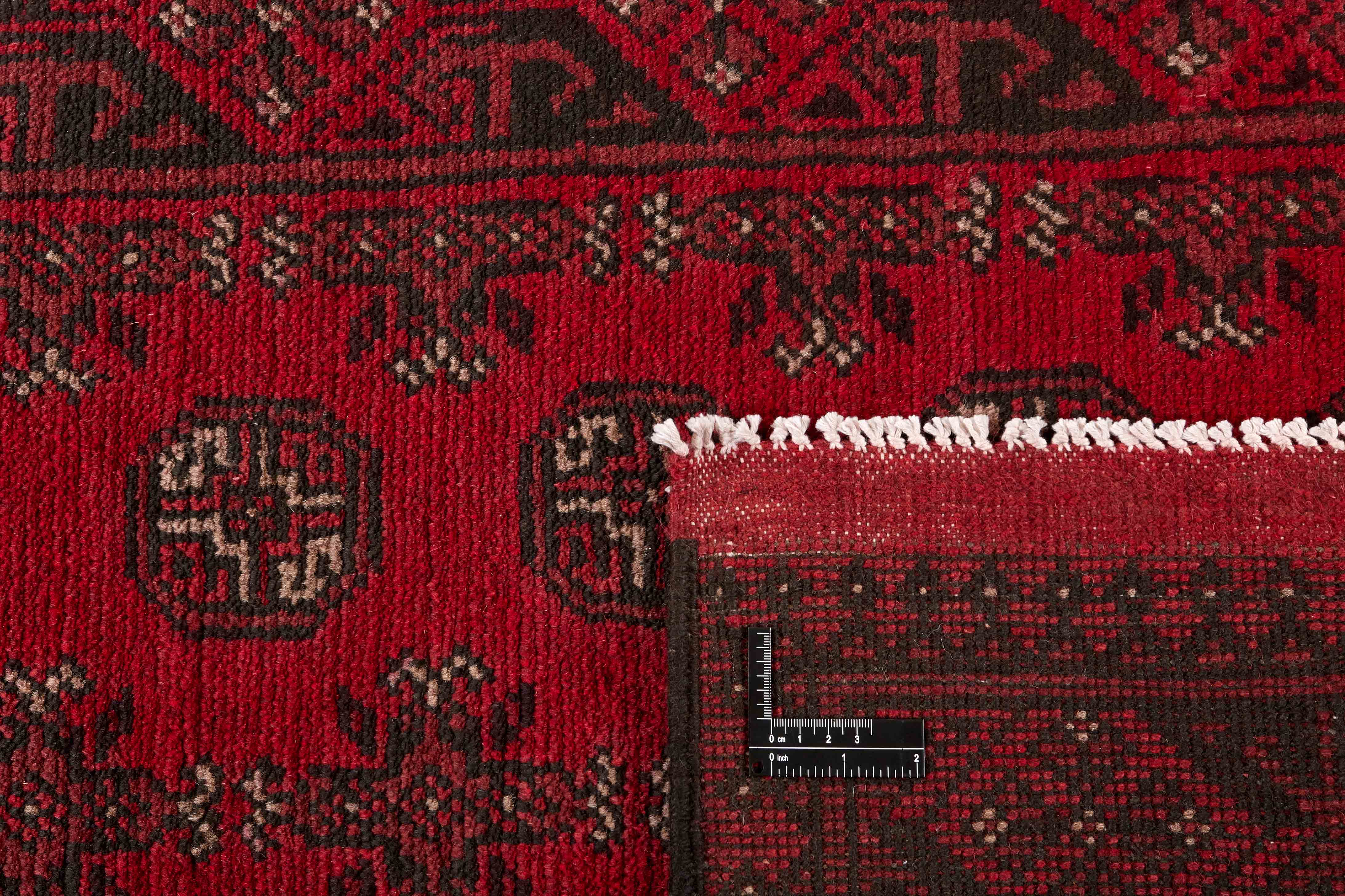 Red Oriental wool runner with a traditional elephant's foot pattern