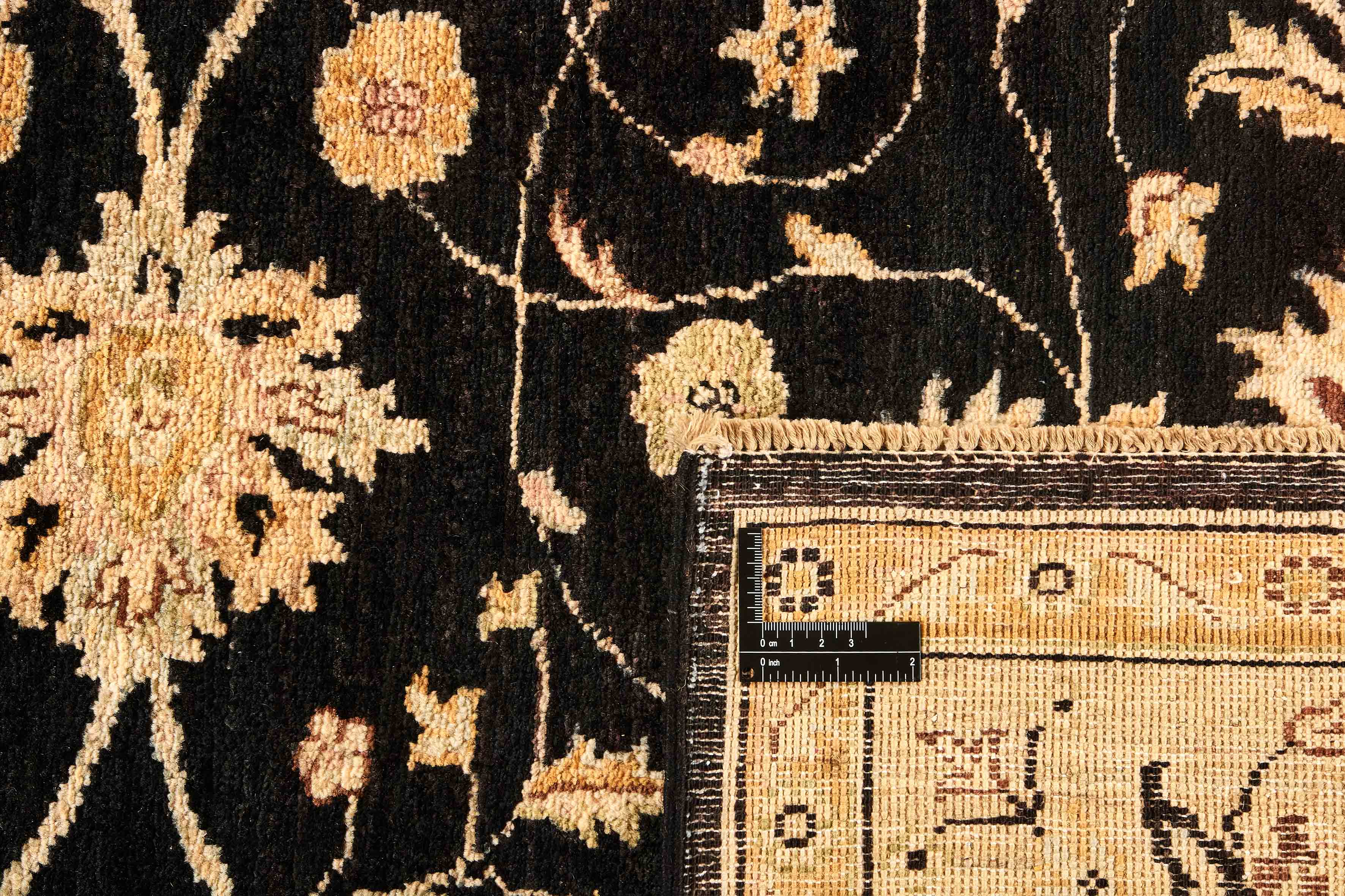 oriental rug with beige and black floral pattern