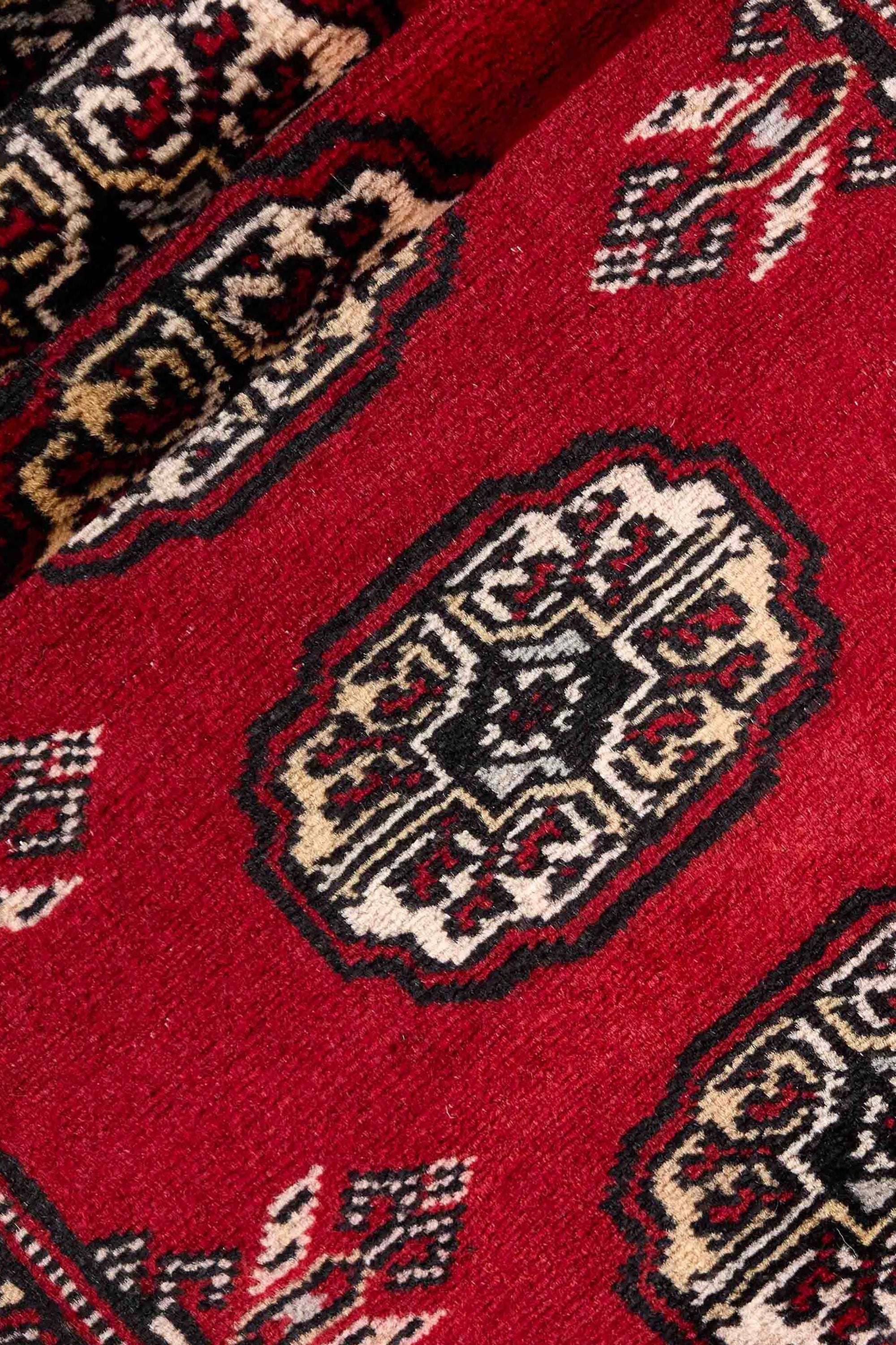 Red Oriental runner with traditional bordered pattern