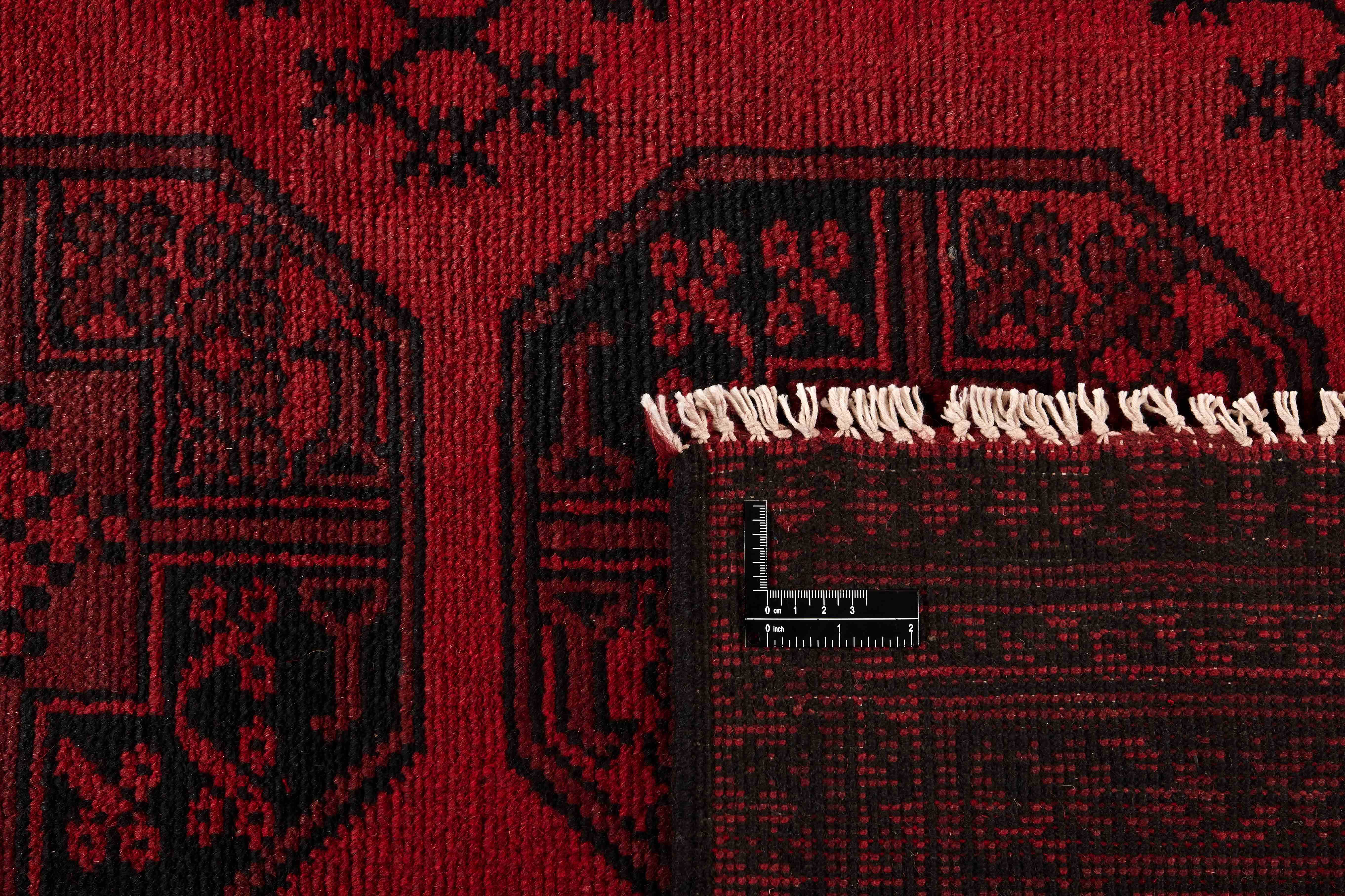 Red oriental rug with traditional elephant's foot pattern