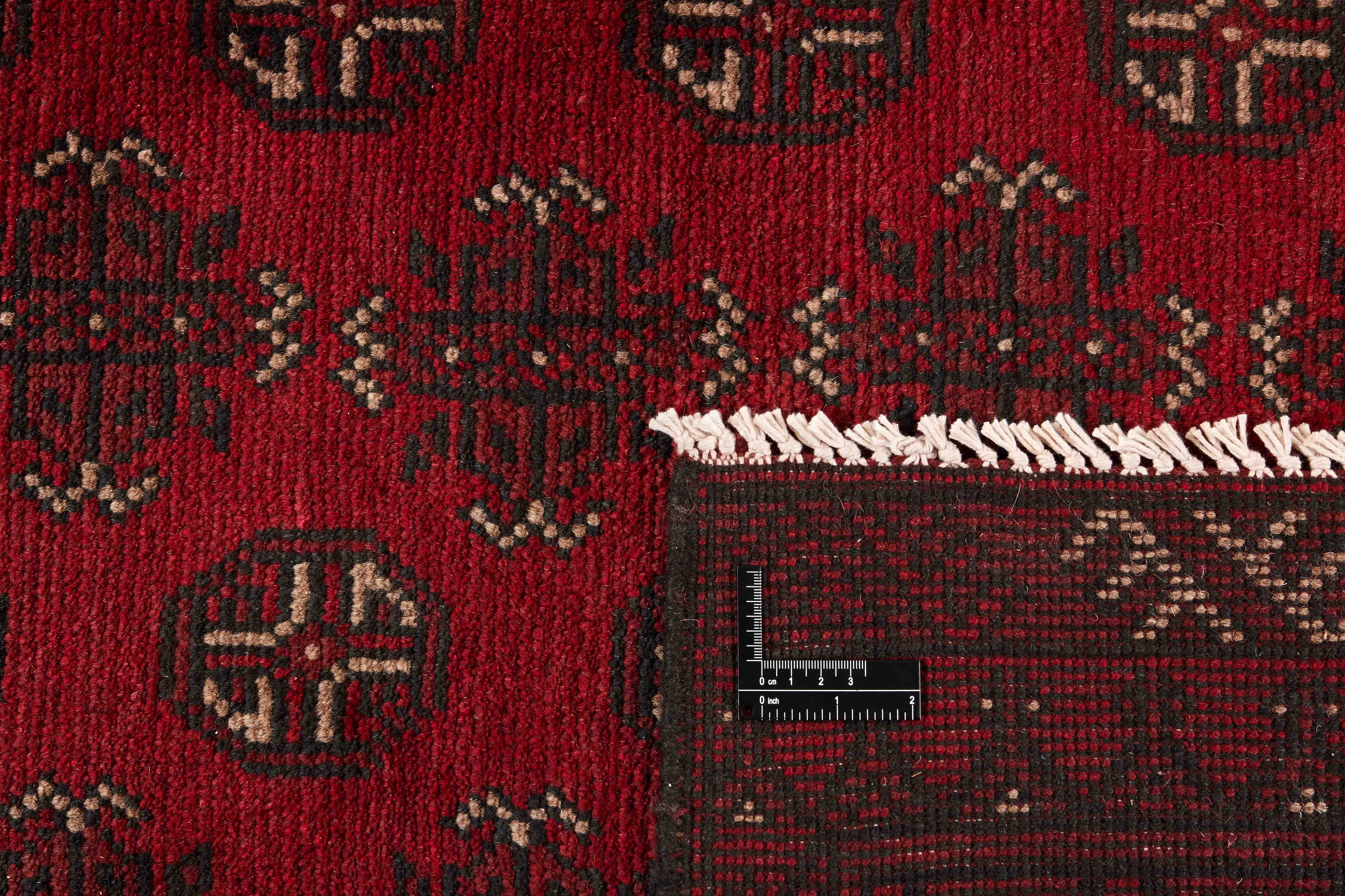 Red oriental rug with traditional elephant's foot pattern