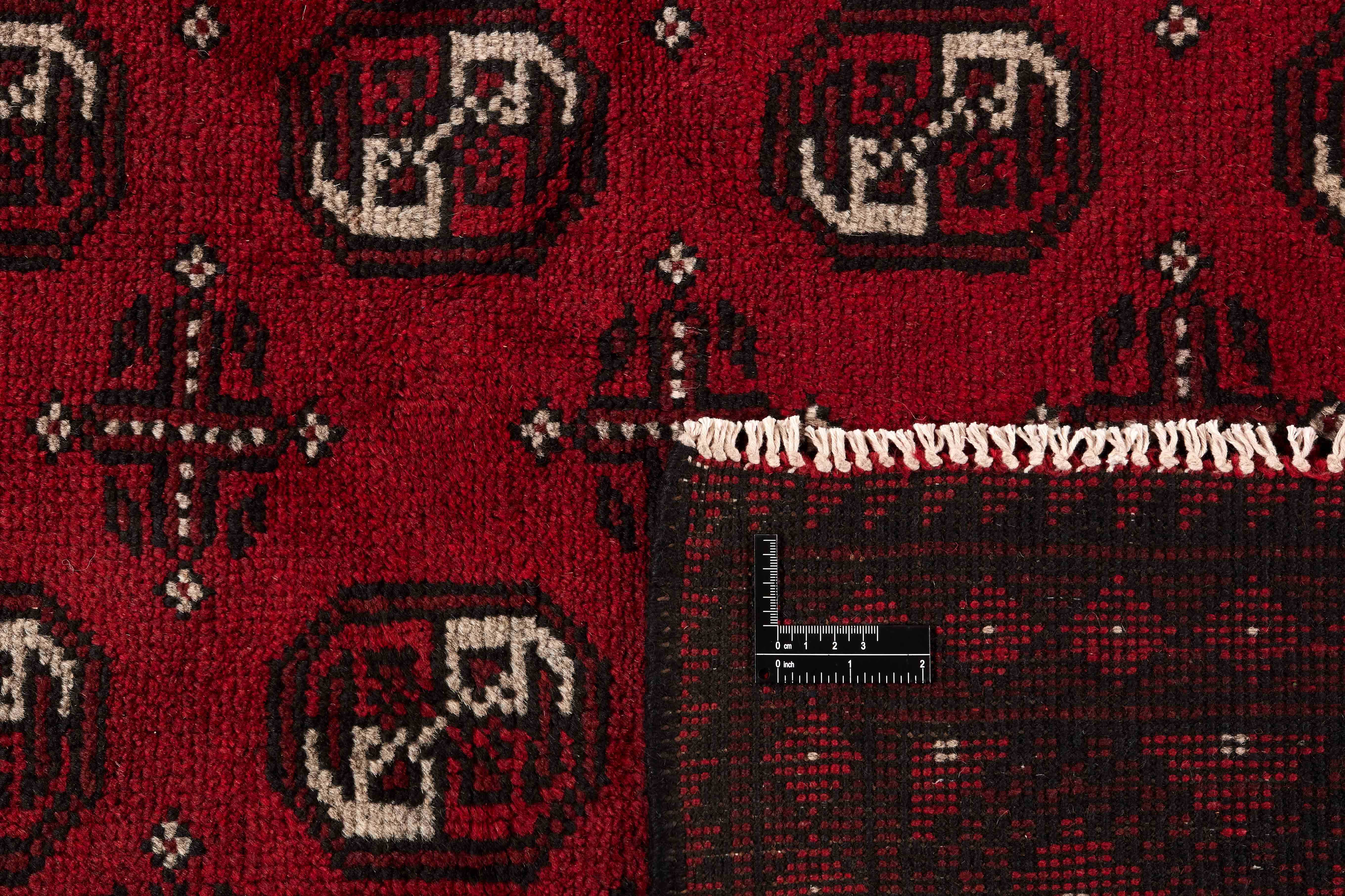 Red oriental rug with traditional elephant's foot pattern