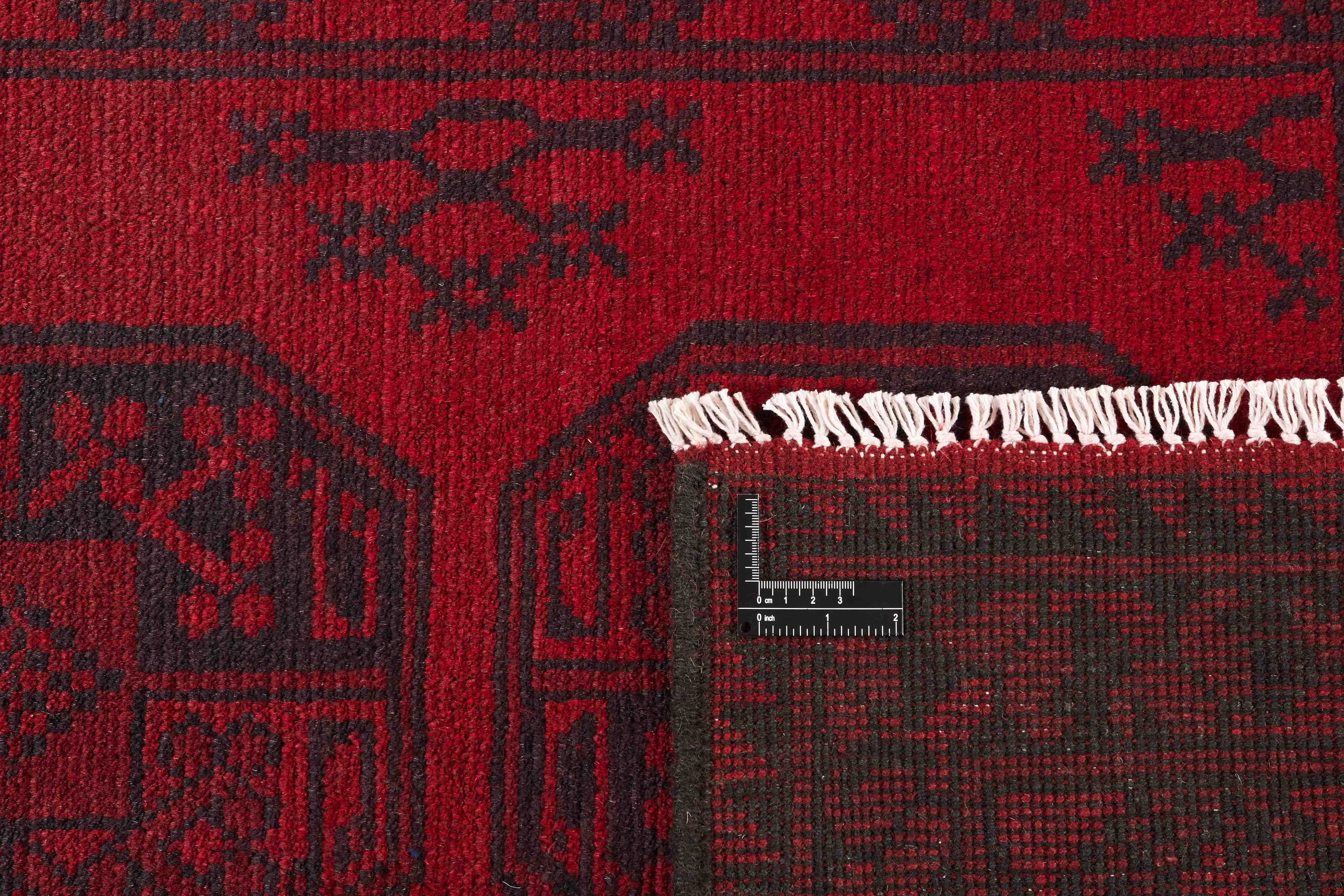 Red Oriental wool runner with a traditional elephant's foot pattern