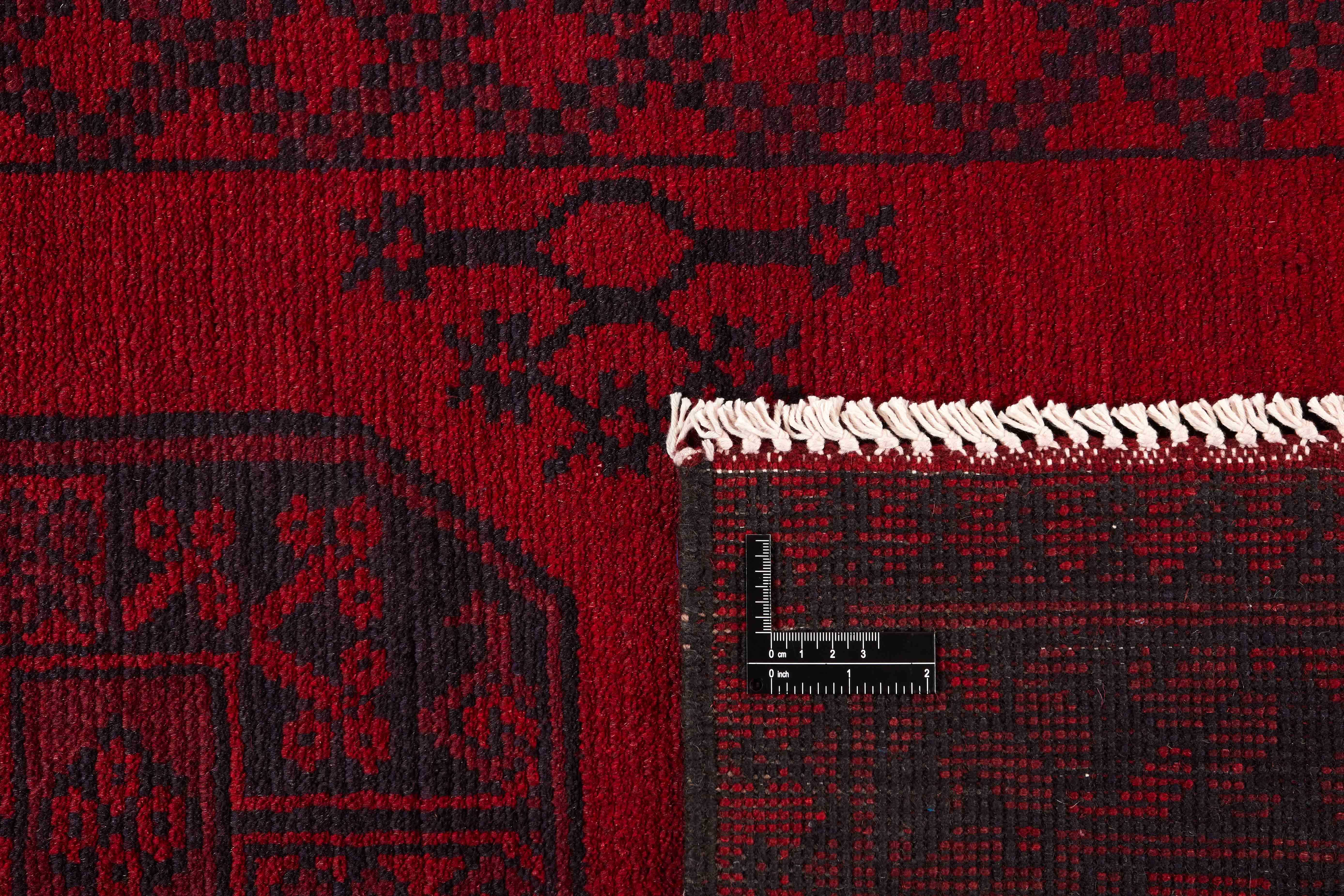 Red Oriental wool runner with a traditional elephant's foot pattern