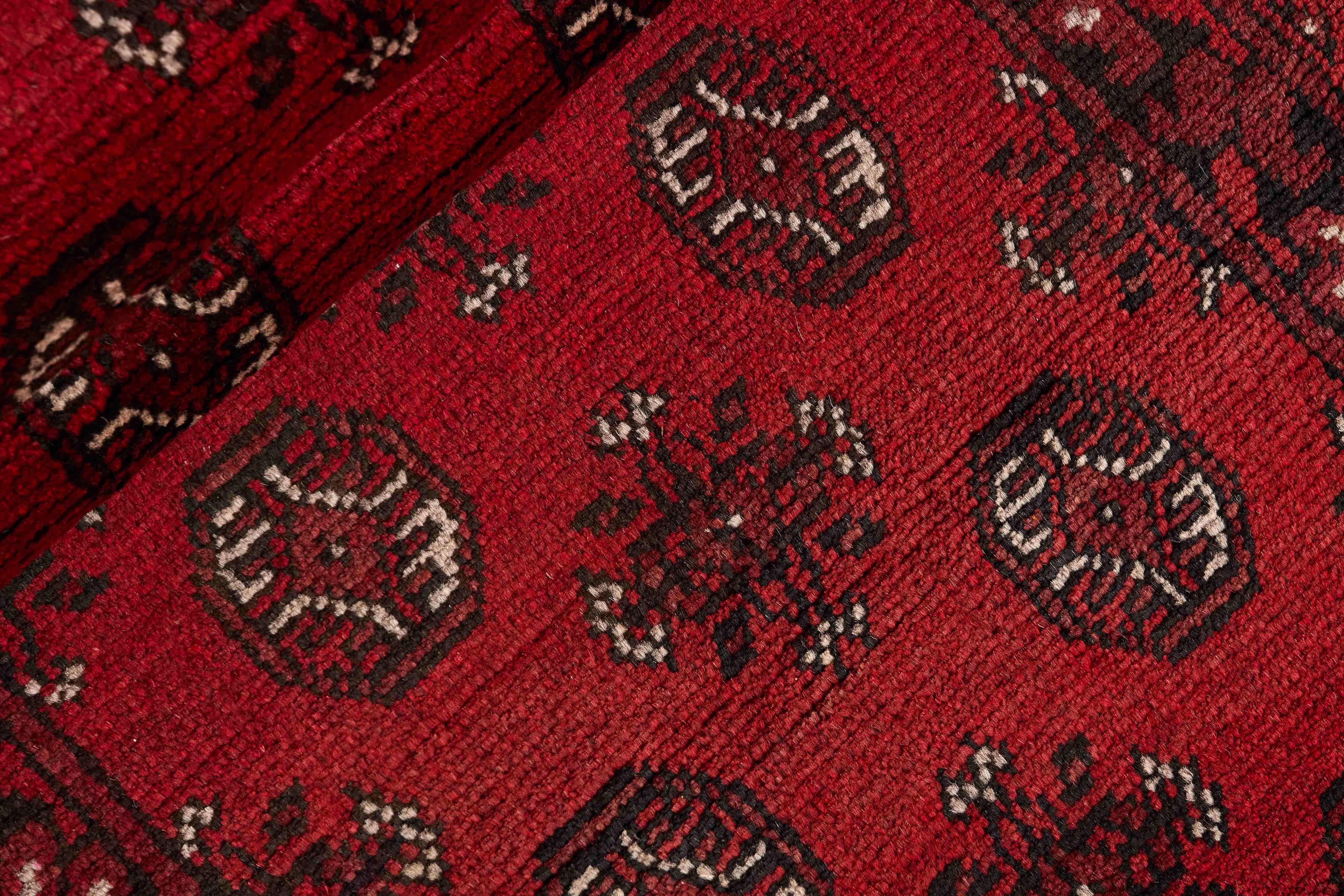 Red Oriental wool runner with a traditional elephant's foot pattern