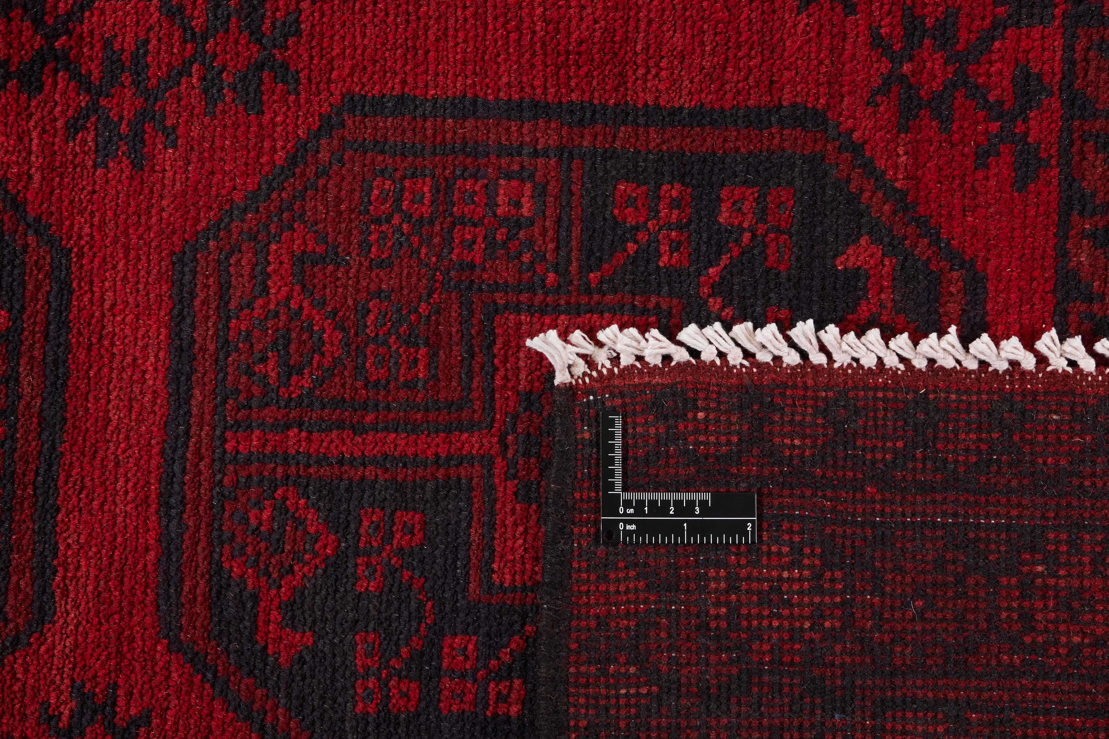 Red oriental rug with traditional elephant's foot pattern