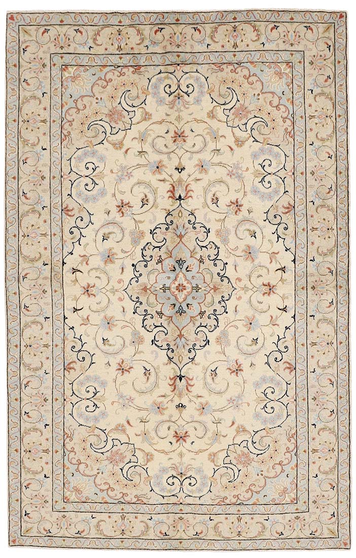 authentic persian rug with traditional floral design in cream, blue, pink and beige
