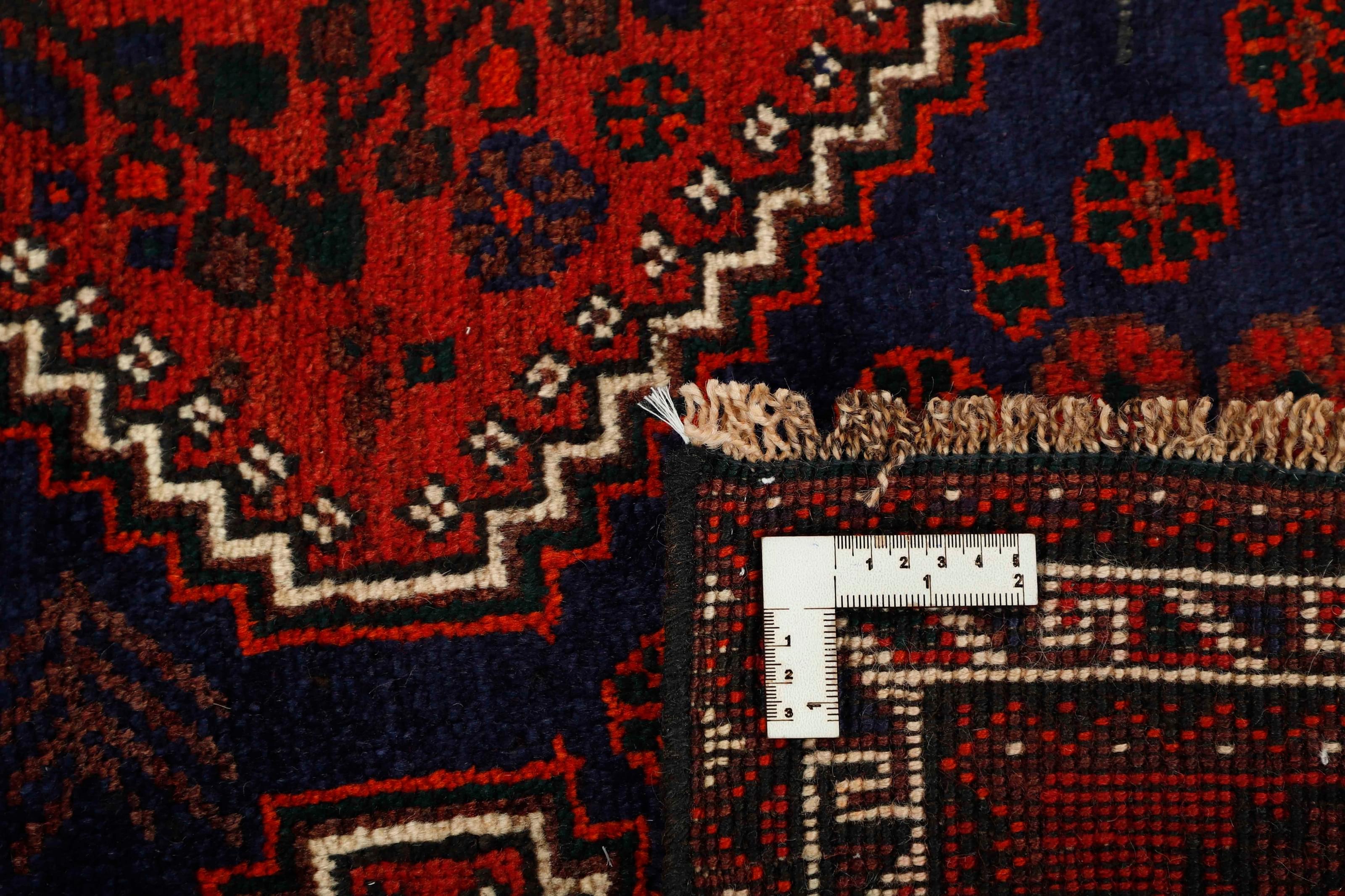 Authentic persian rug with a traditional tribal geometric pattern in red