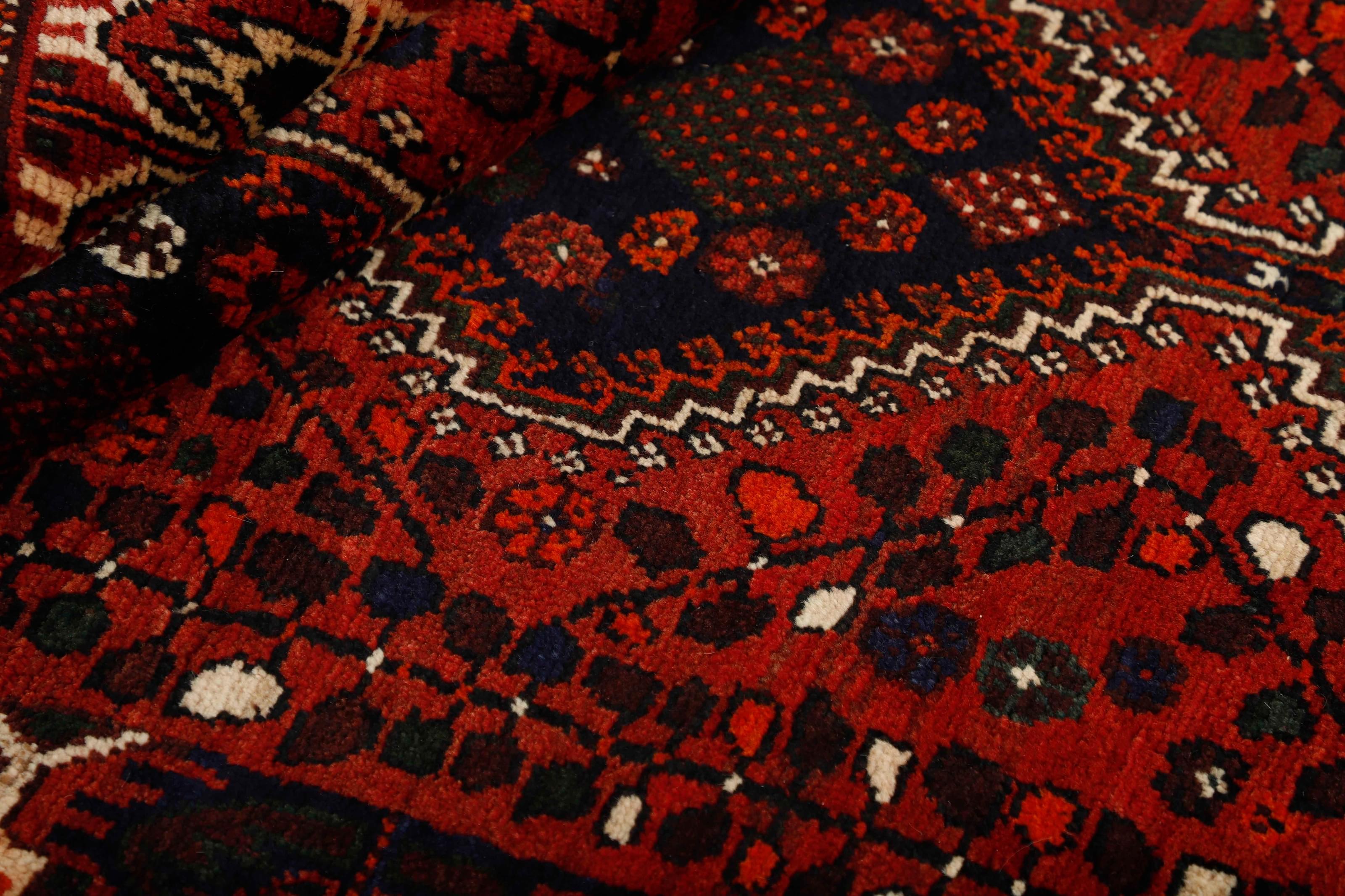 Authentic persian rug with a traditional tribal geometric pattern in red