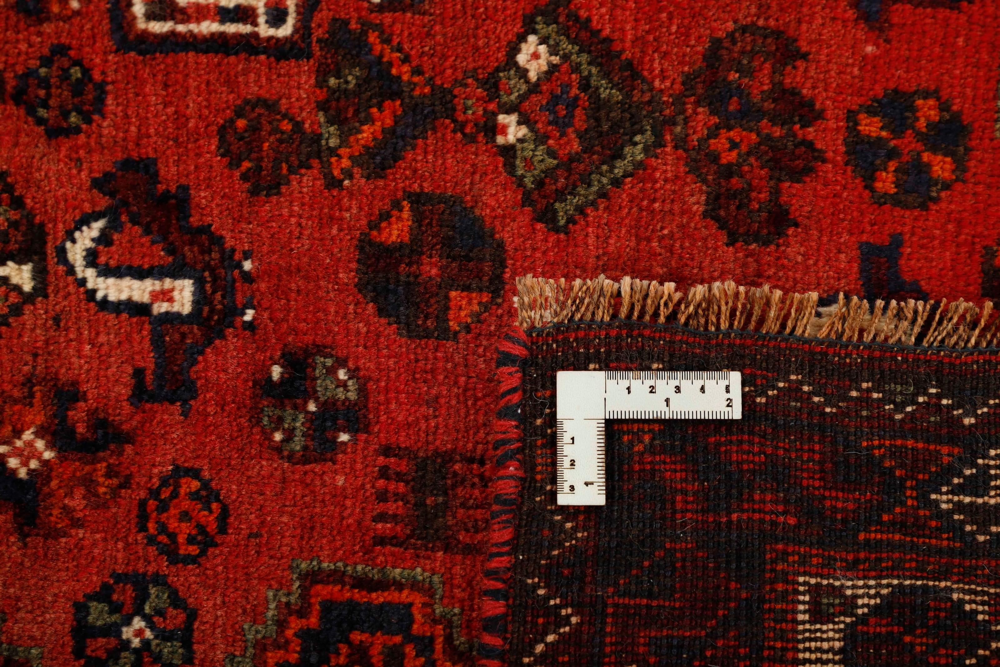 Authentic persian rug with a traditional tribal geometric pattern in red