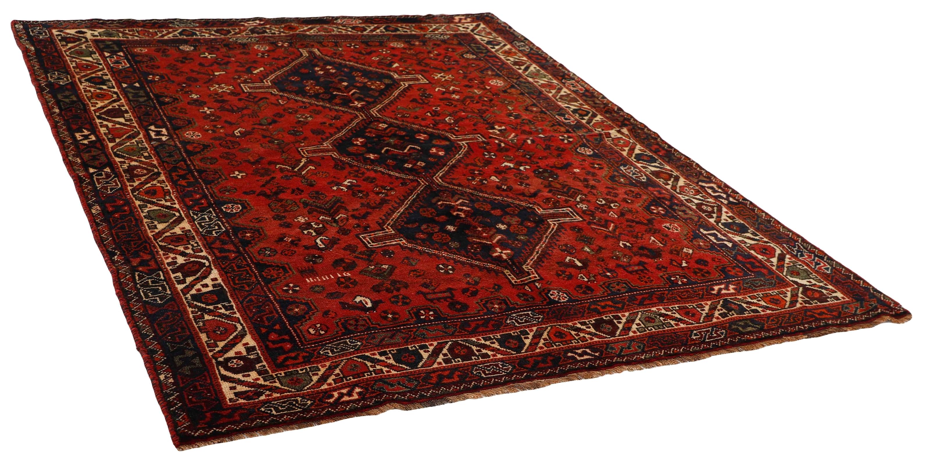 Authentic persian rug with a traditional tribal geometric pattern in red