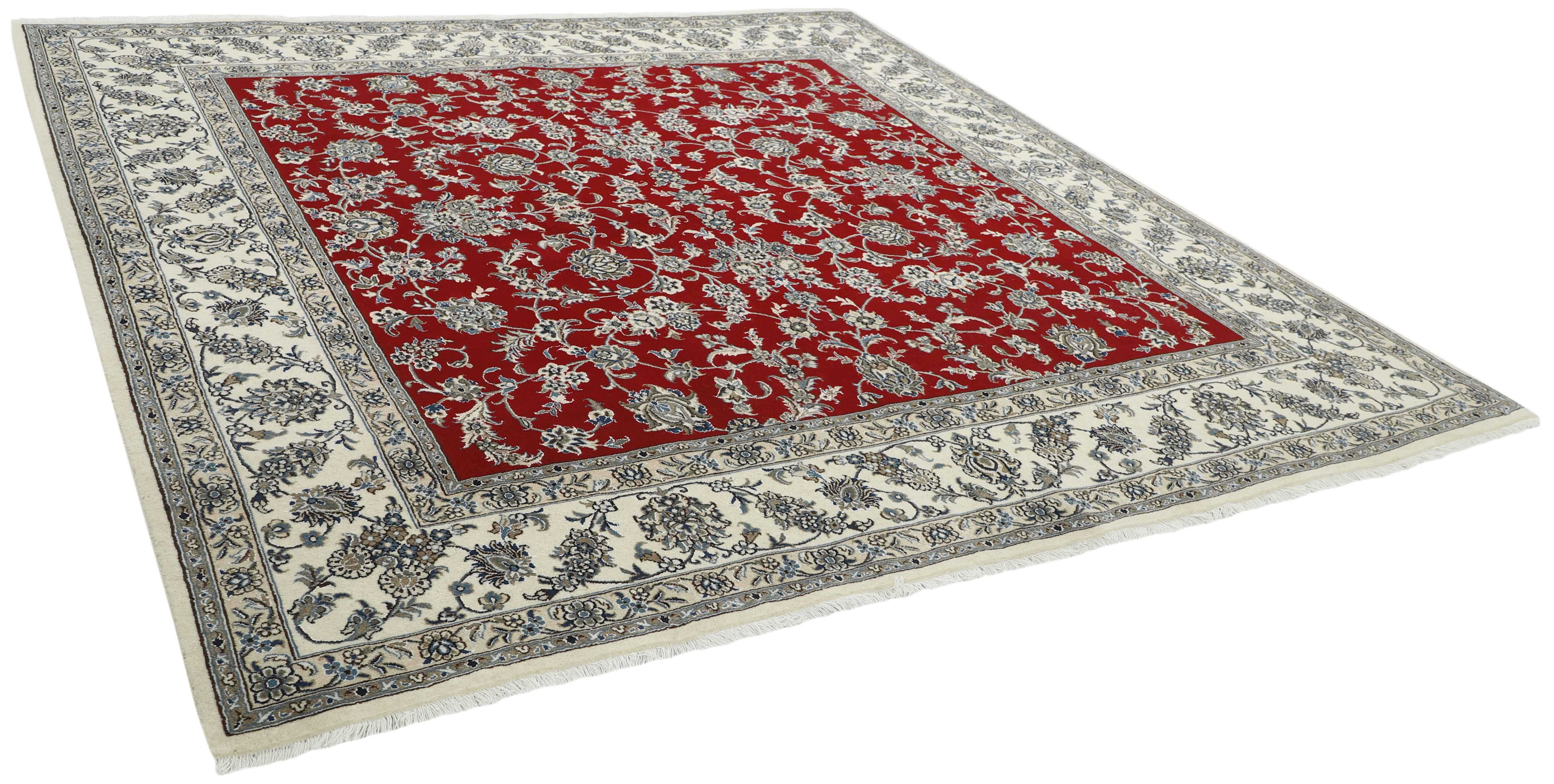 Authentic persian rug with a traditional floral design in cream and red