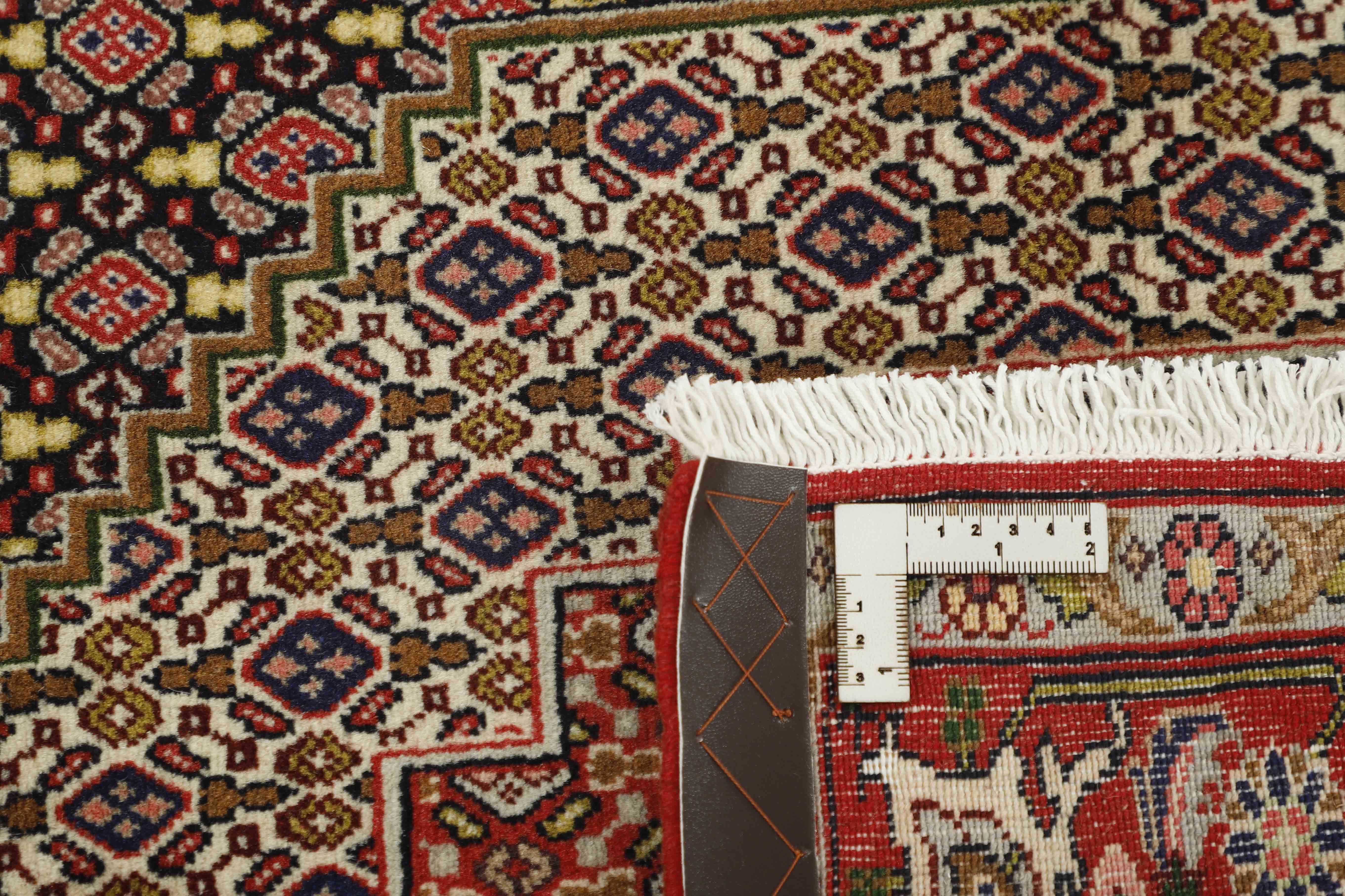 authentic persian rug with a traditional geometric design in red