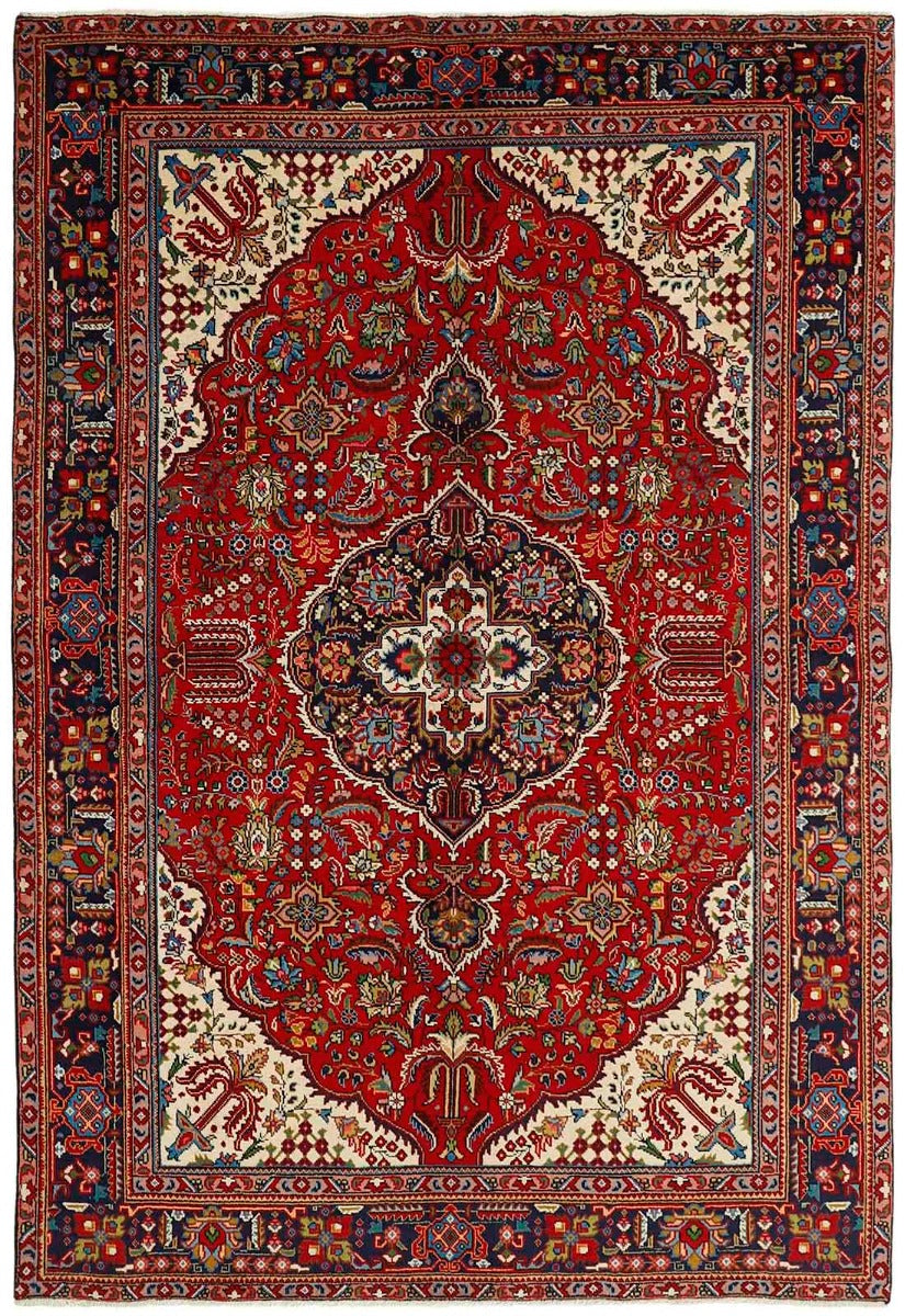 authentic persian rug with traditional floral design in red, black, beige and green
